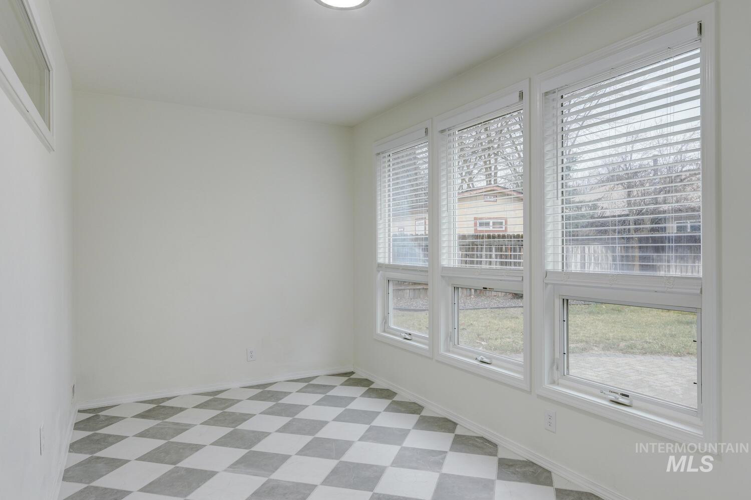 Empty room featuring light floors and baseboards