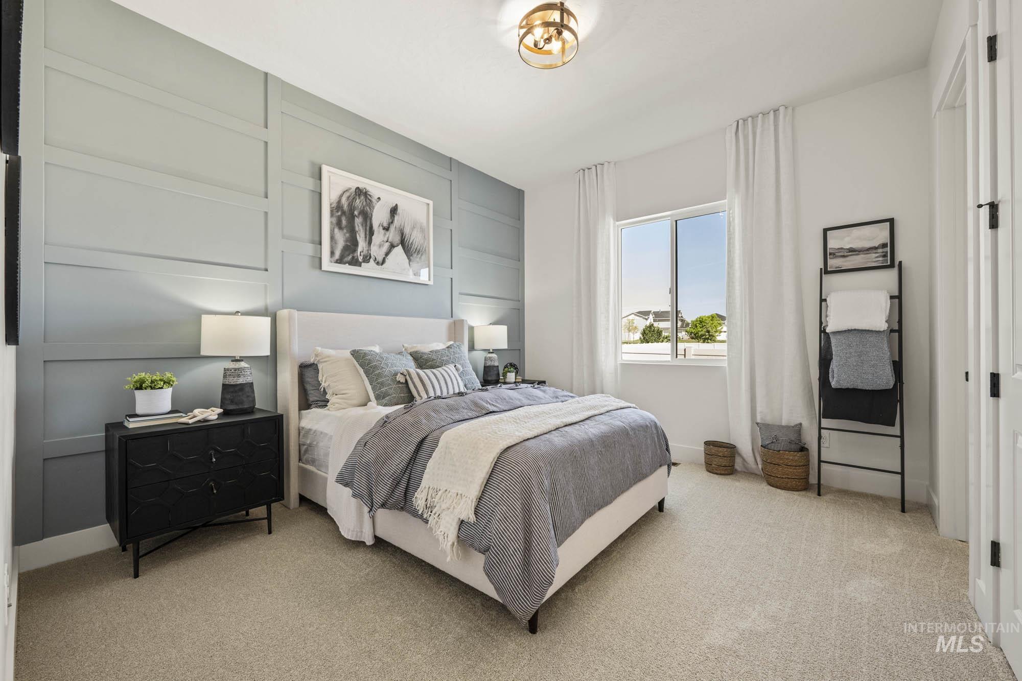 Bedroom featuring a decorative wall and light colored carpet