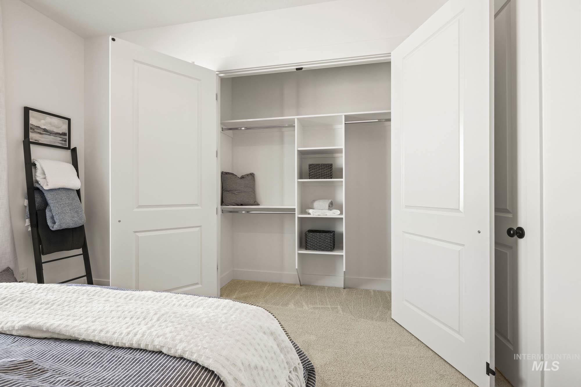 Bedroom featuring a closet and light carpet