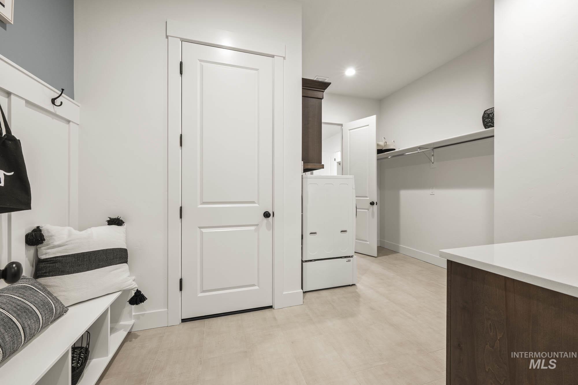 Mudroom featuring washer / dryer, recessed lighting, and light floors
