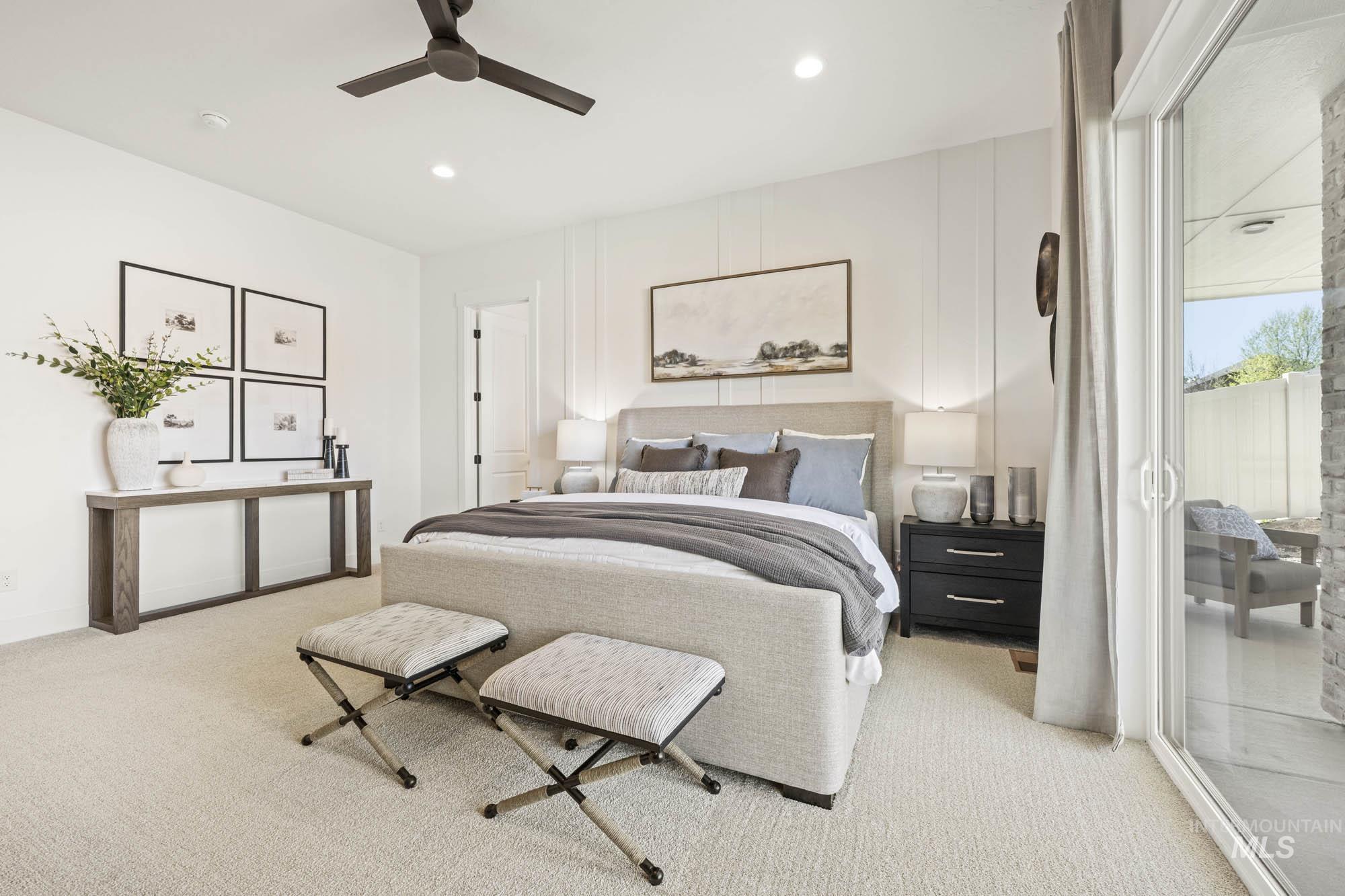 Bedroom featuring ceiling fan and light colored carpet