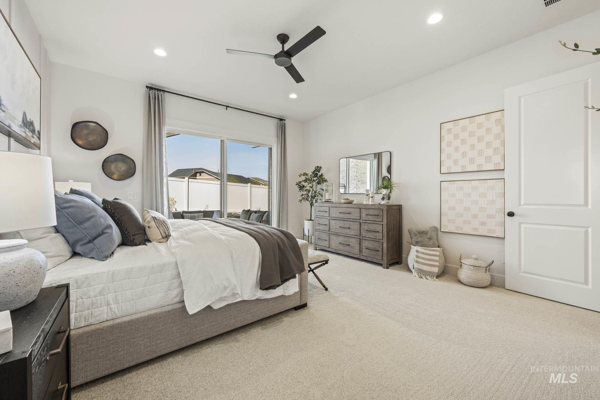Carpeted bedroom with a ceiling fan, access to outside, and recessed lighting