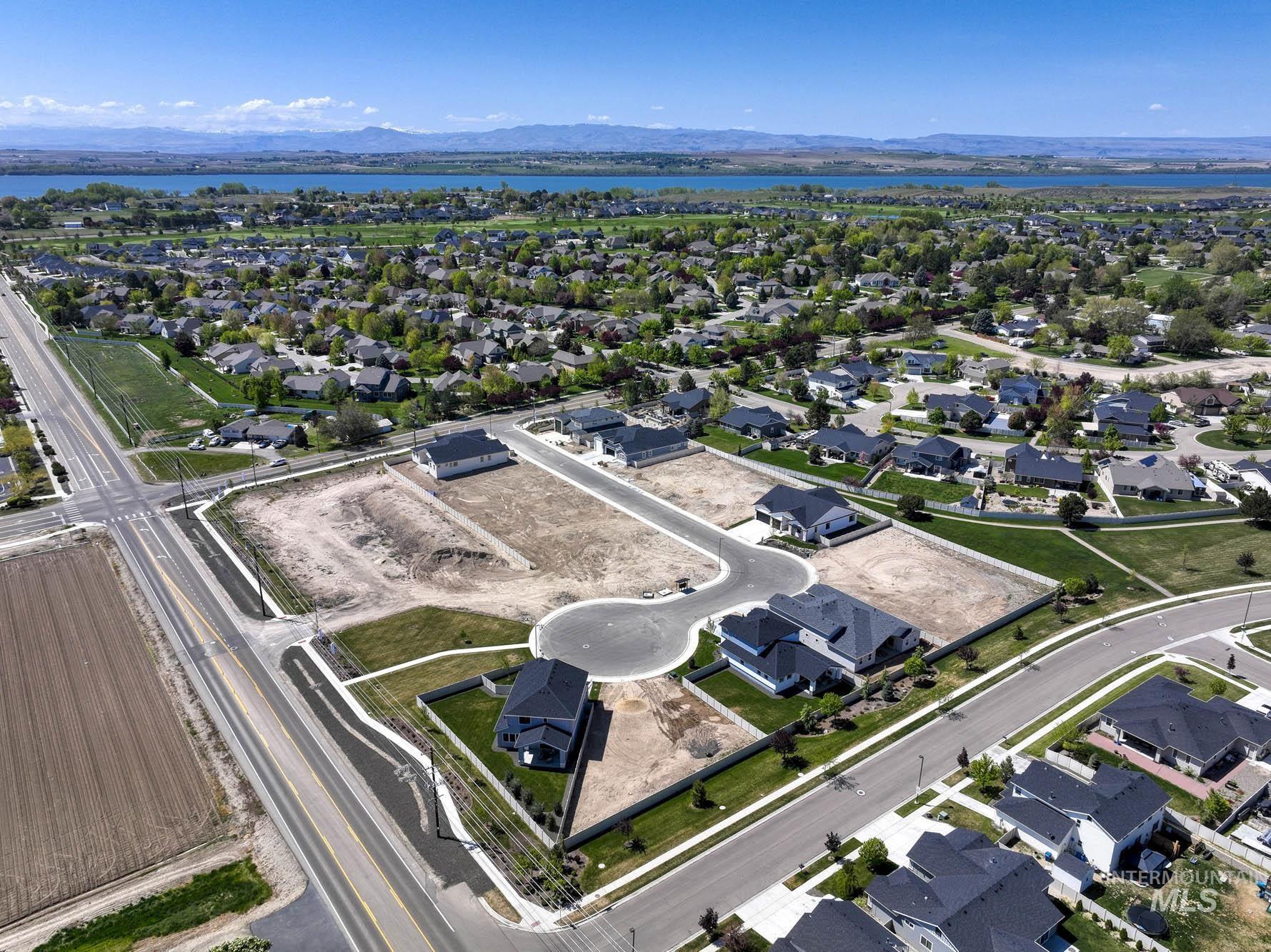 Aerial overview of property's location with nearby suburban area and a water and mountain view