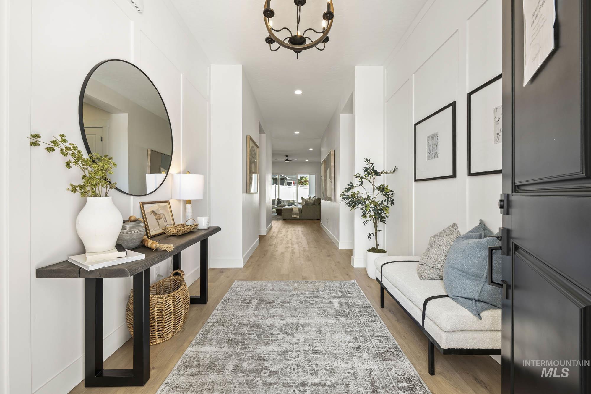 Corridor with light wood-style flooring, a chandelier, and recessed lighting