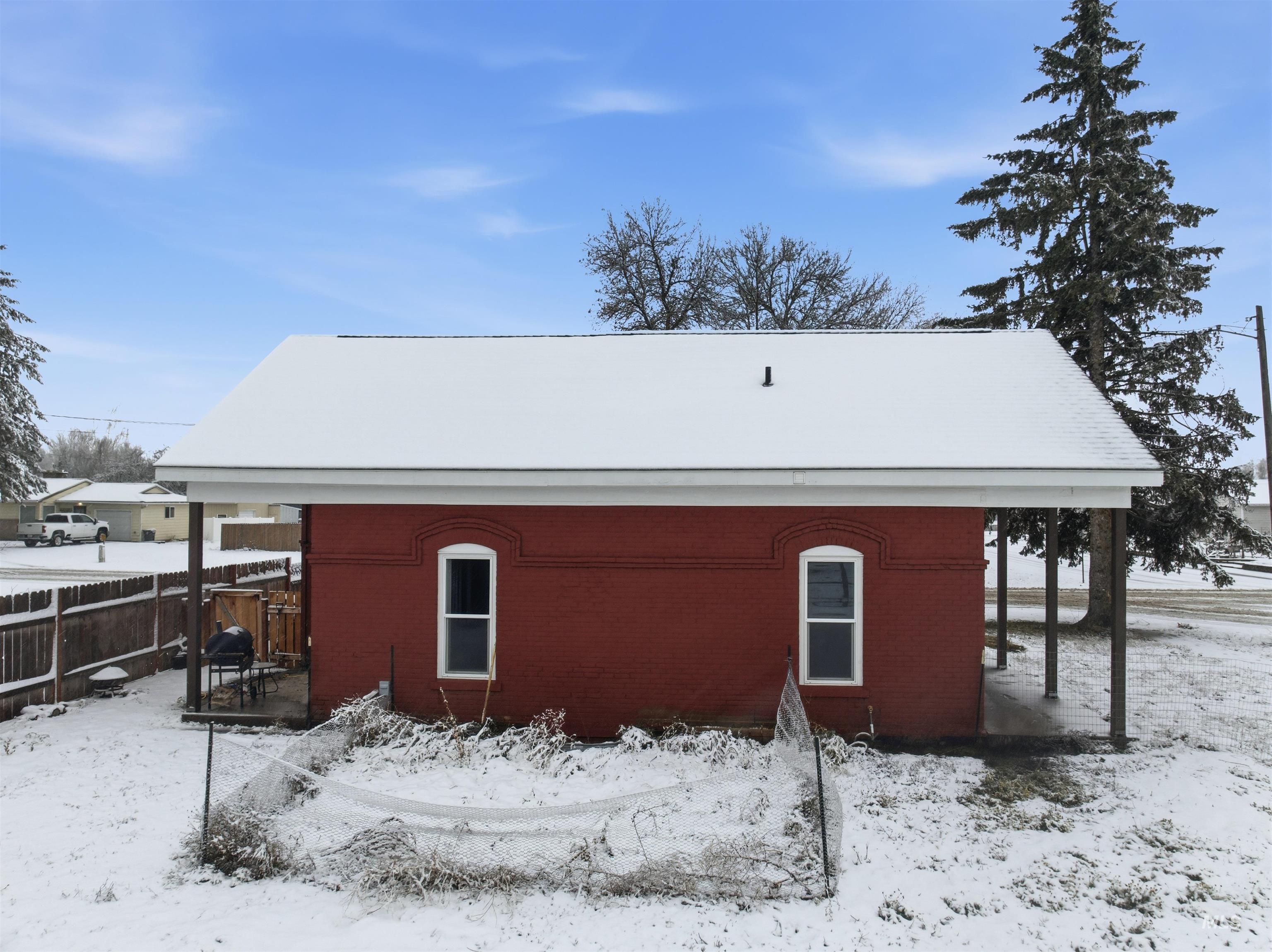 View of snowy exterior with brick siding