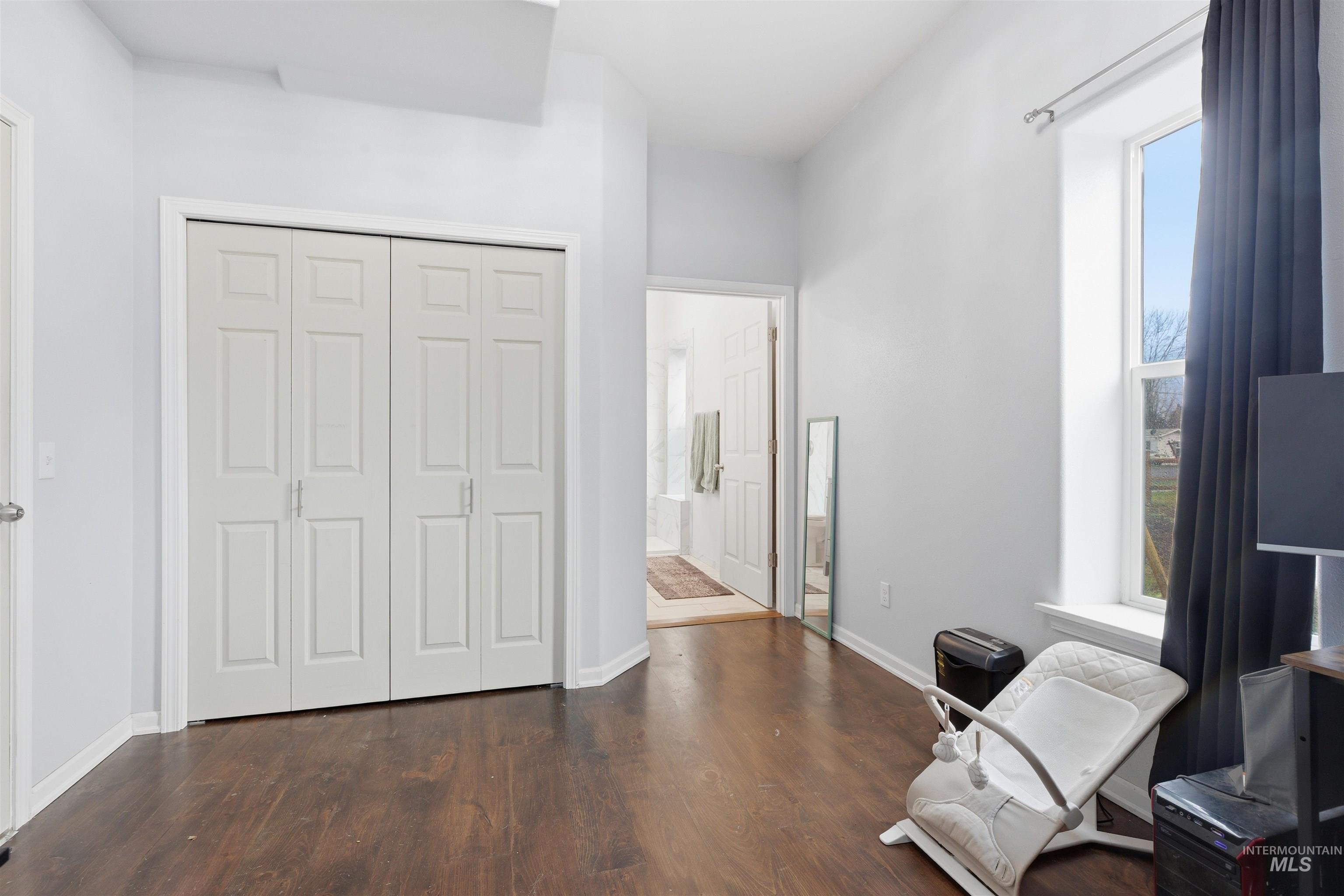Sitting room featuring dark wood finished floors and baseboards