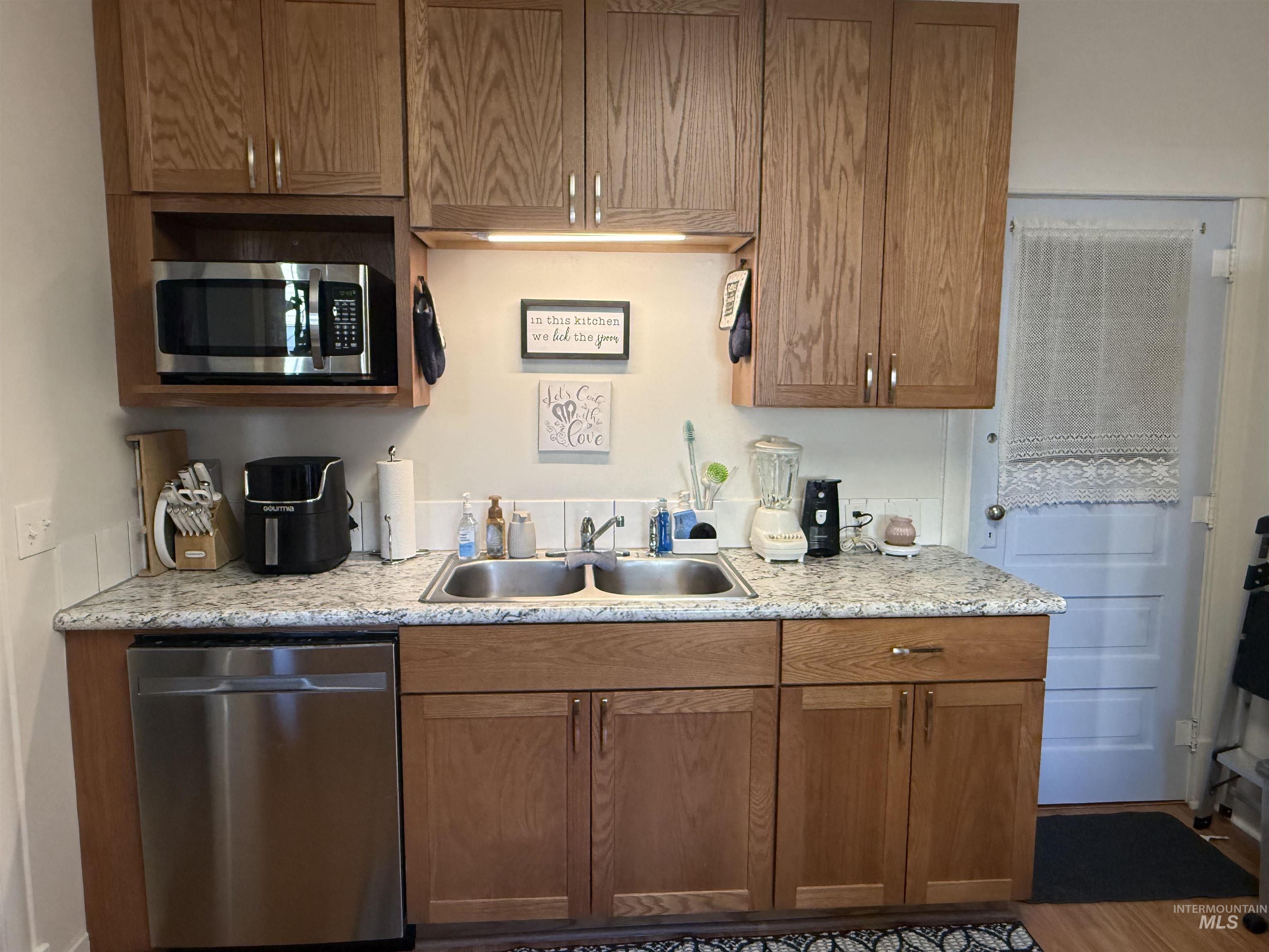 Kitchen with stainless steel appliances and brown cabinets