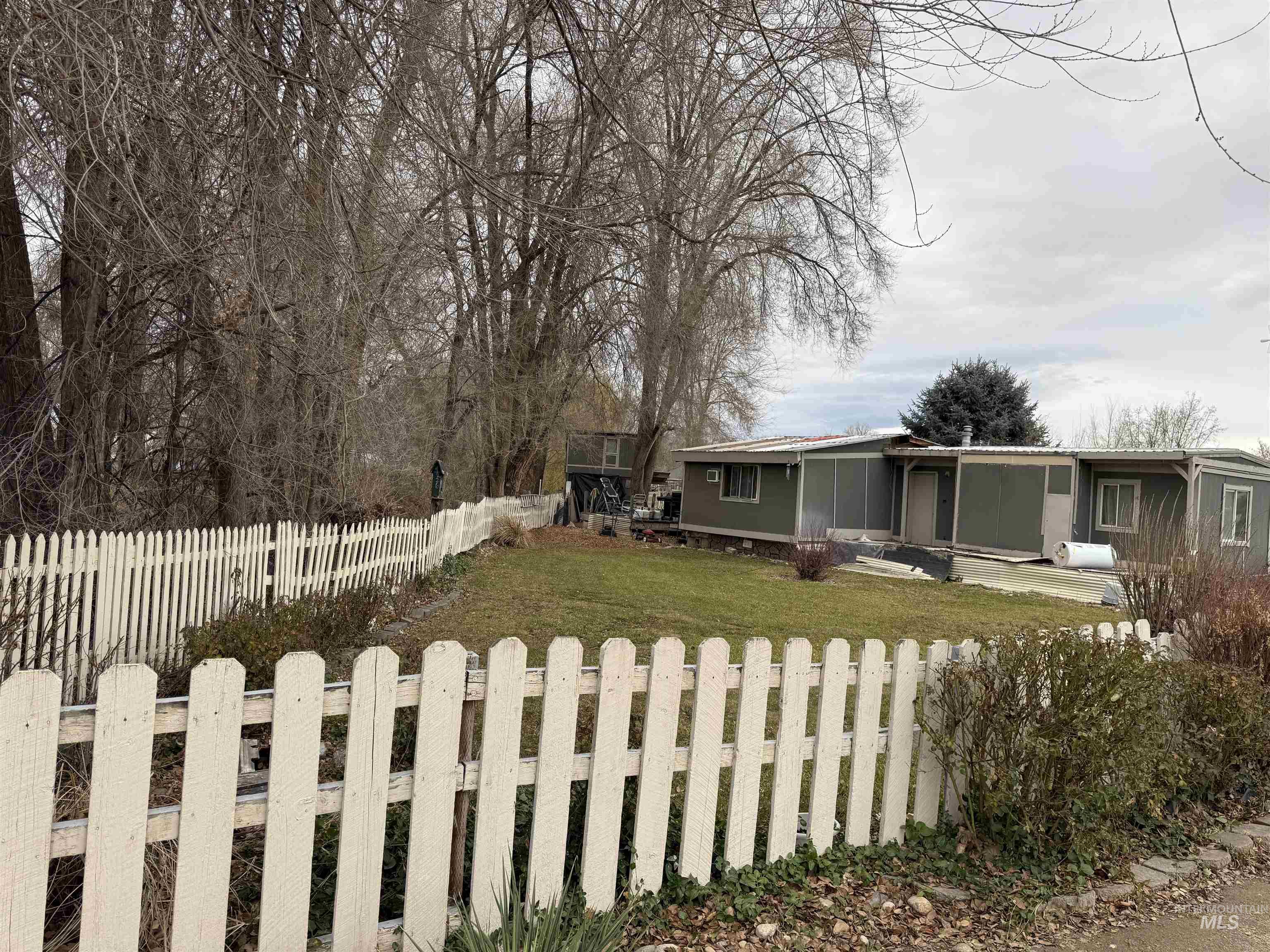 View of front facade with a fenced backyard and a patio area