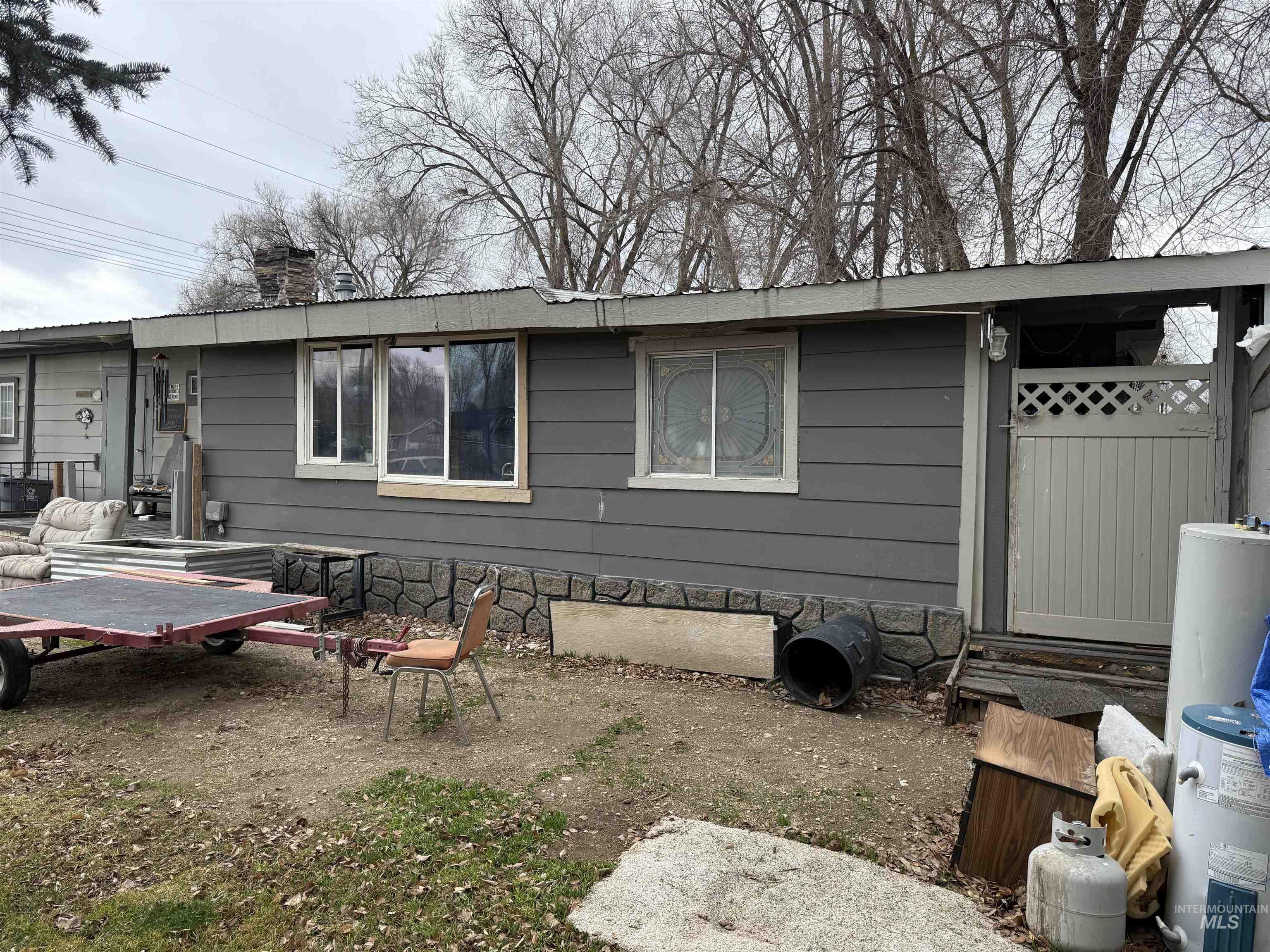 Rear view of house with a chimney, a patio area, and entry steps