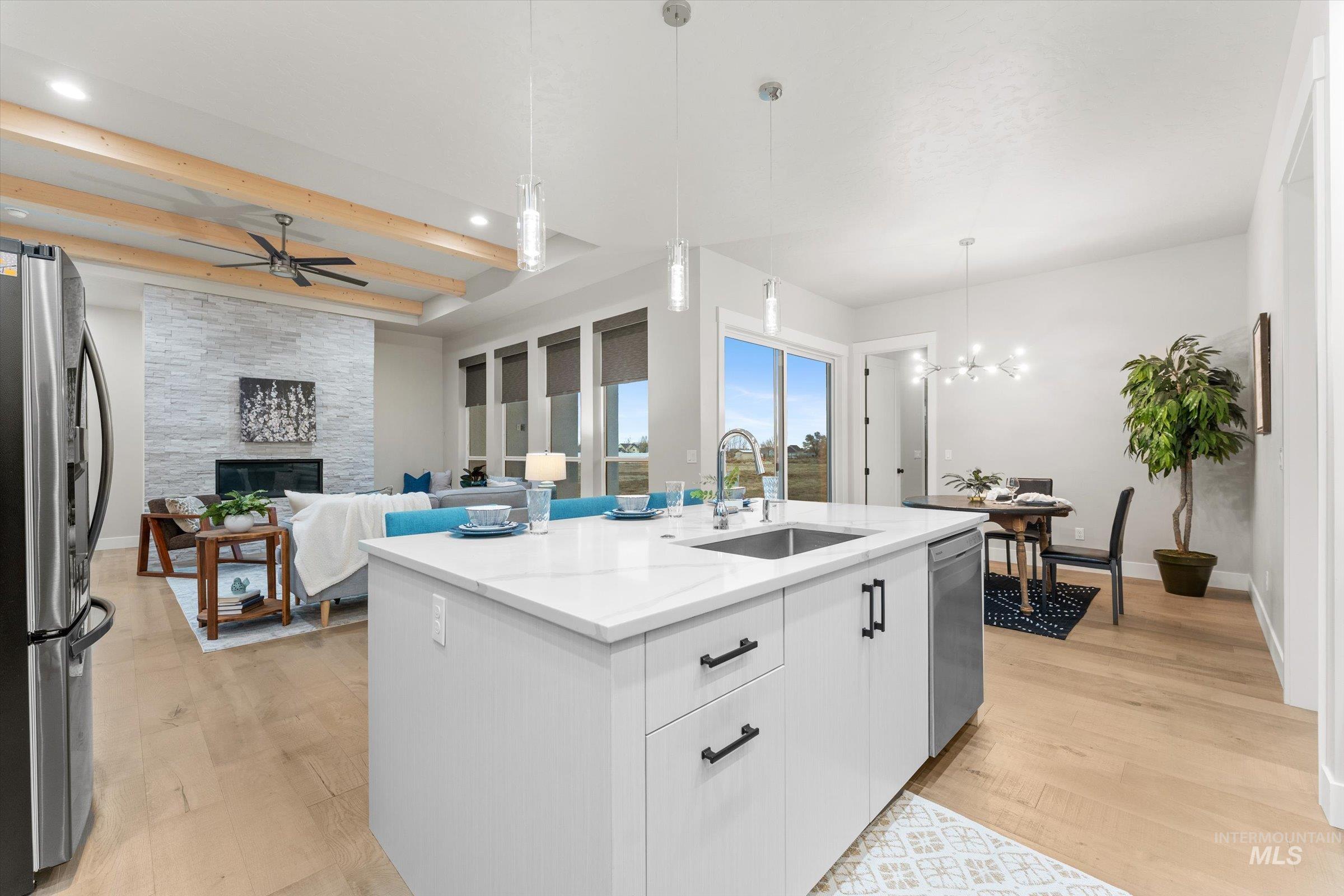 Kitchen featuring pendant lighting, light wood finished floors, appliances with stainless steel finishes, white cabinets, and recessed lighting