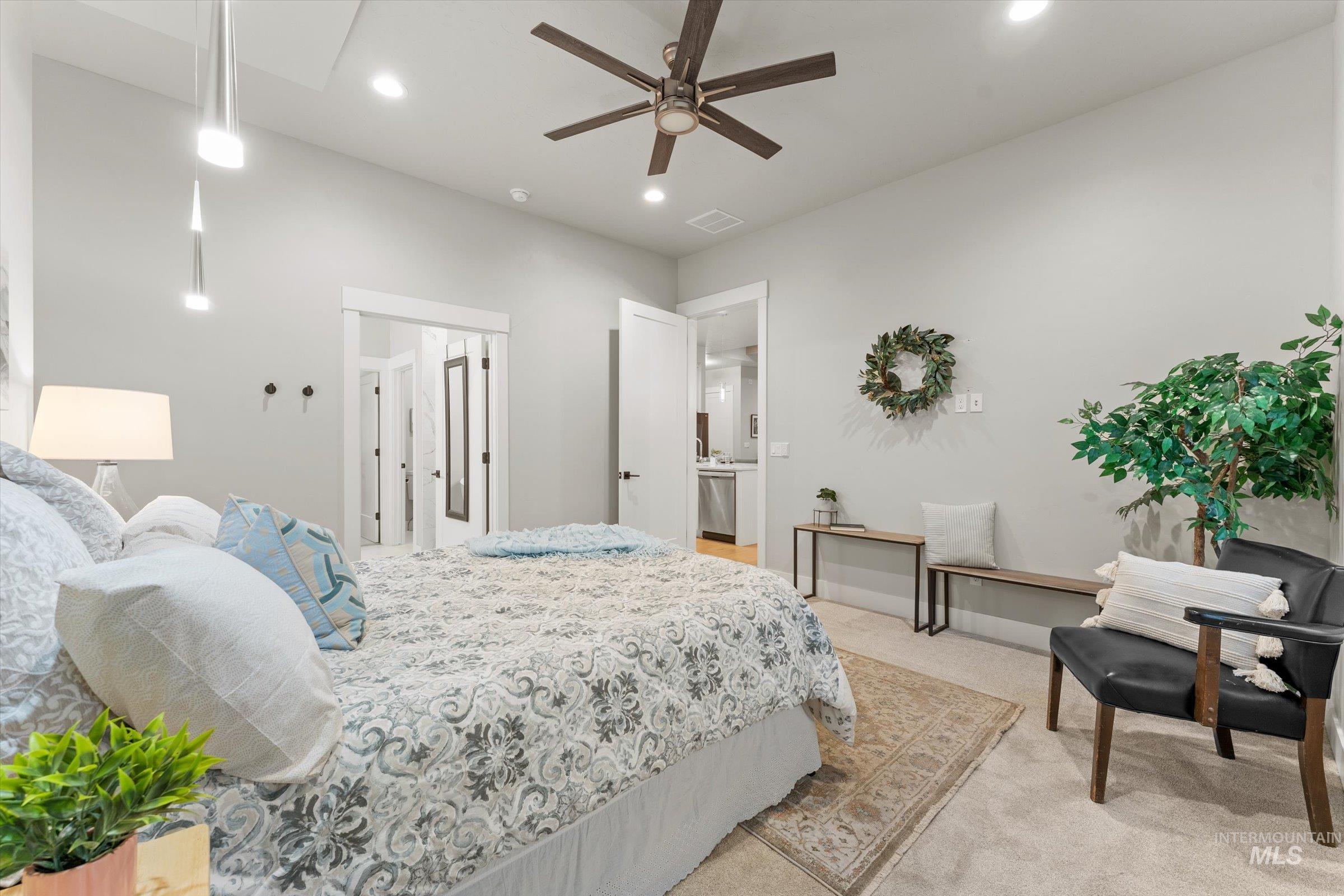 Carpeted bedroom with ceiling fan and recessed lighting