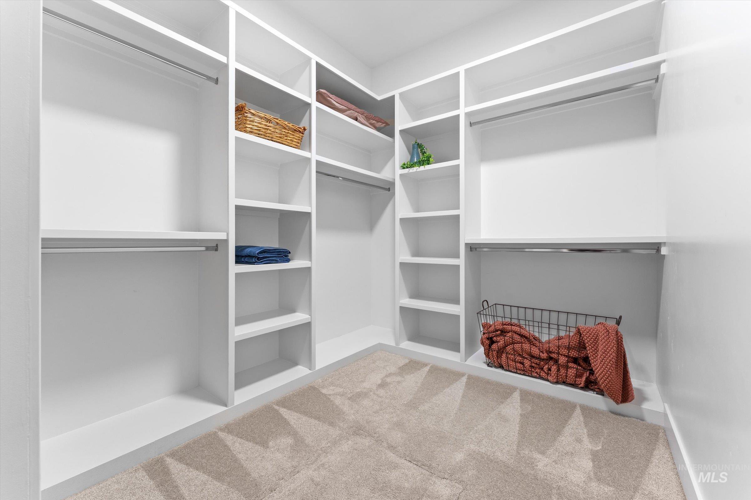 Spacious closet featuring ample shelving and storage space