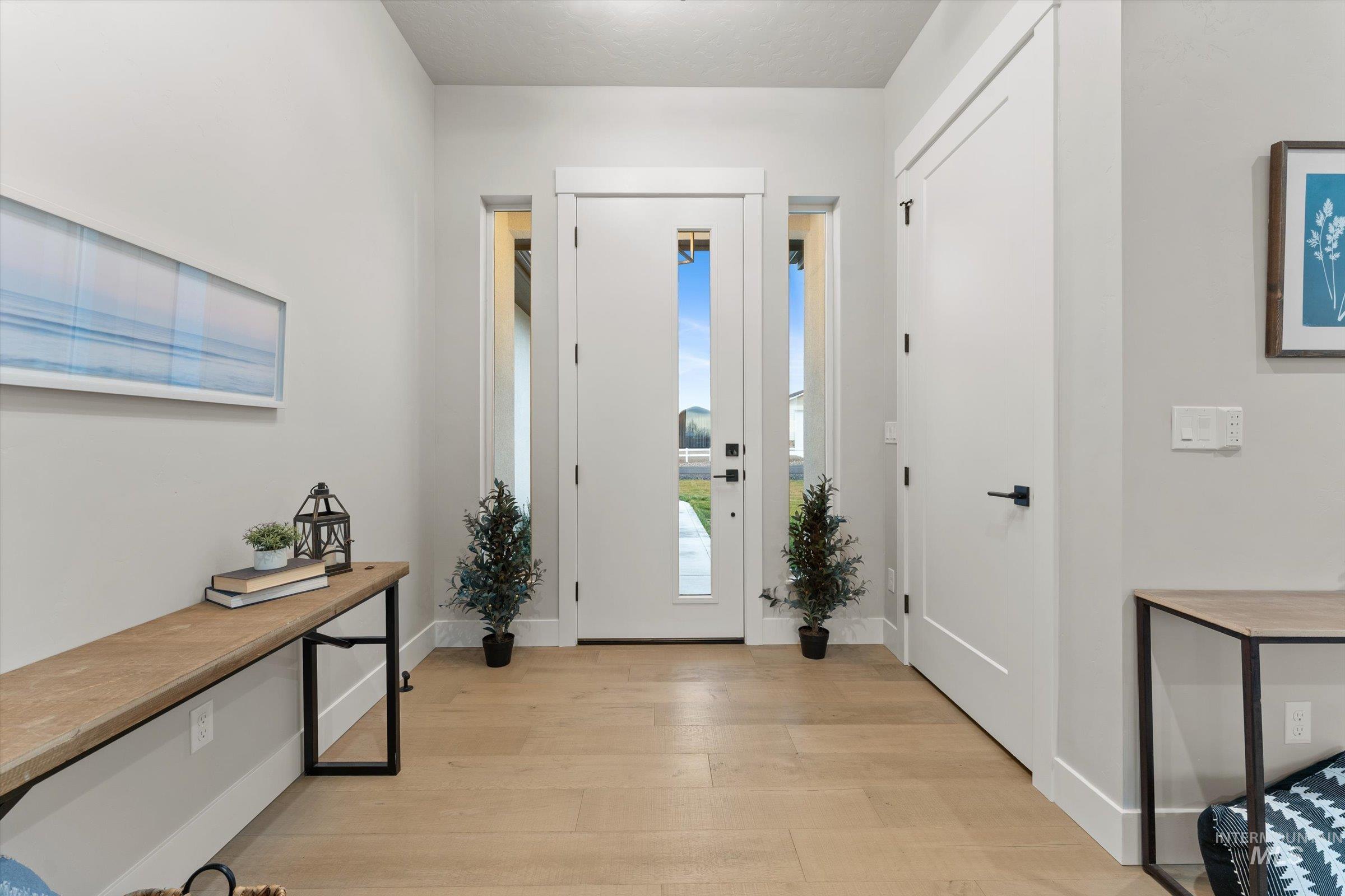 Foyer entrance with light wood-style flooring