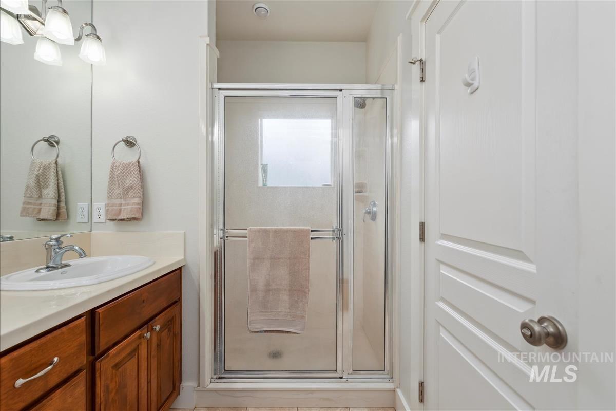 Full bathroom featuring a shower stall and vanity