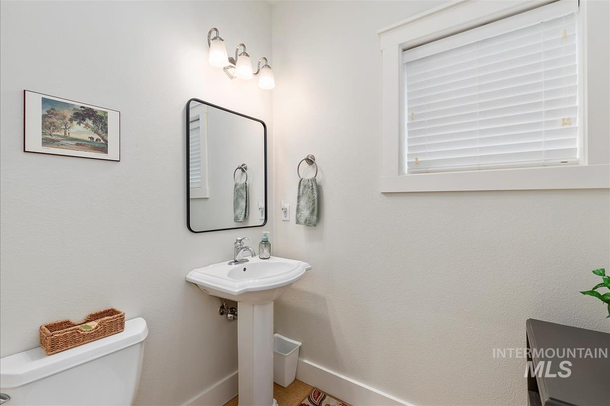 Half bath with toilet and baseboards