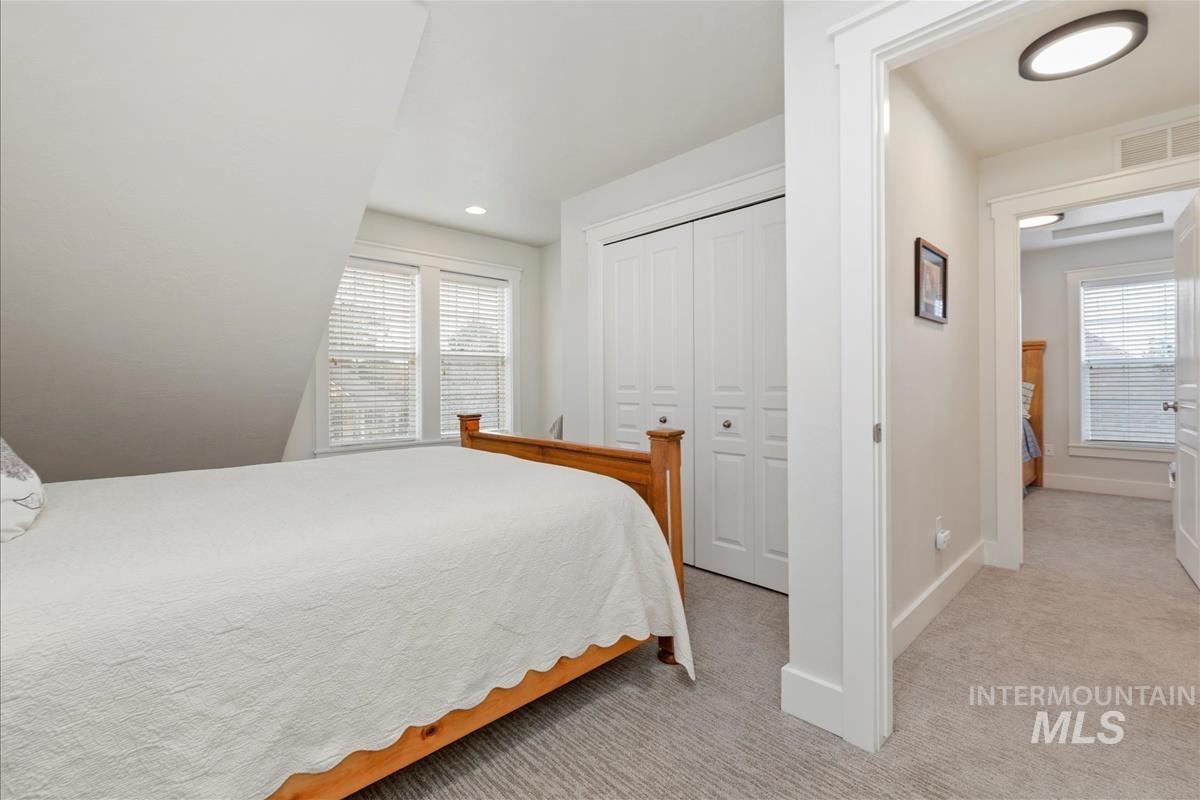 Bedroom featuring light carpet, a closet, and recessed lighting