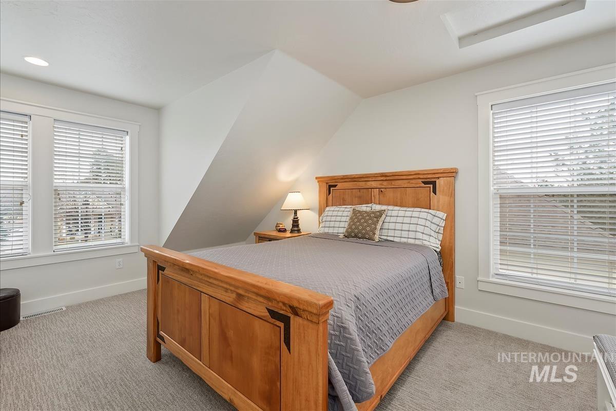 Bedroom with light colored carpet