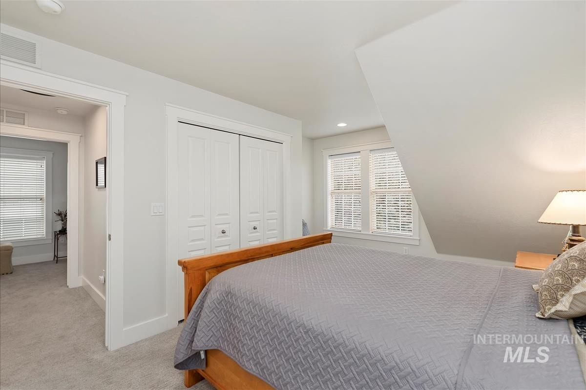 Bedroom featuring carpet floors, multiple windows, a closet, and recessed lighting