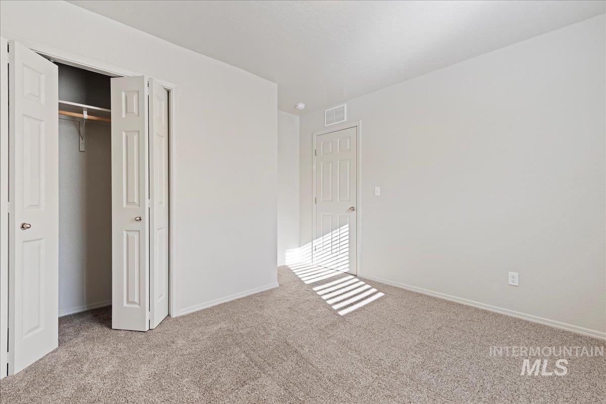 Unfurnished bedroom with a closet and carpet