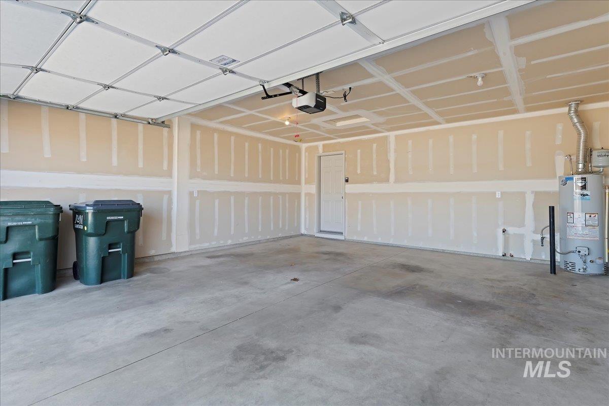 Garage with water heater and a garage door opener