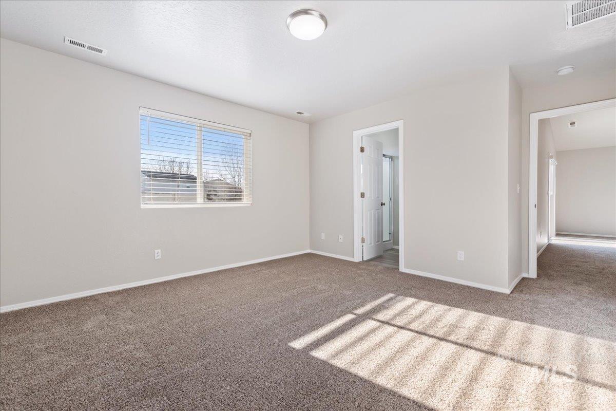Unfurnished bedroom with carpet and baseboards