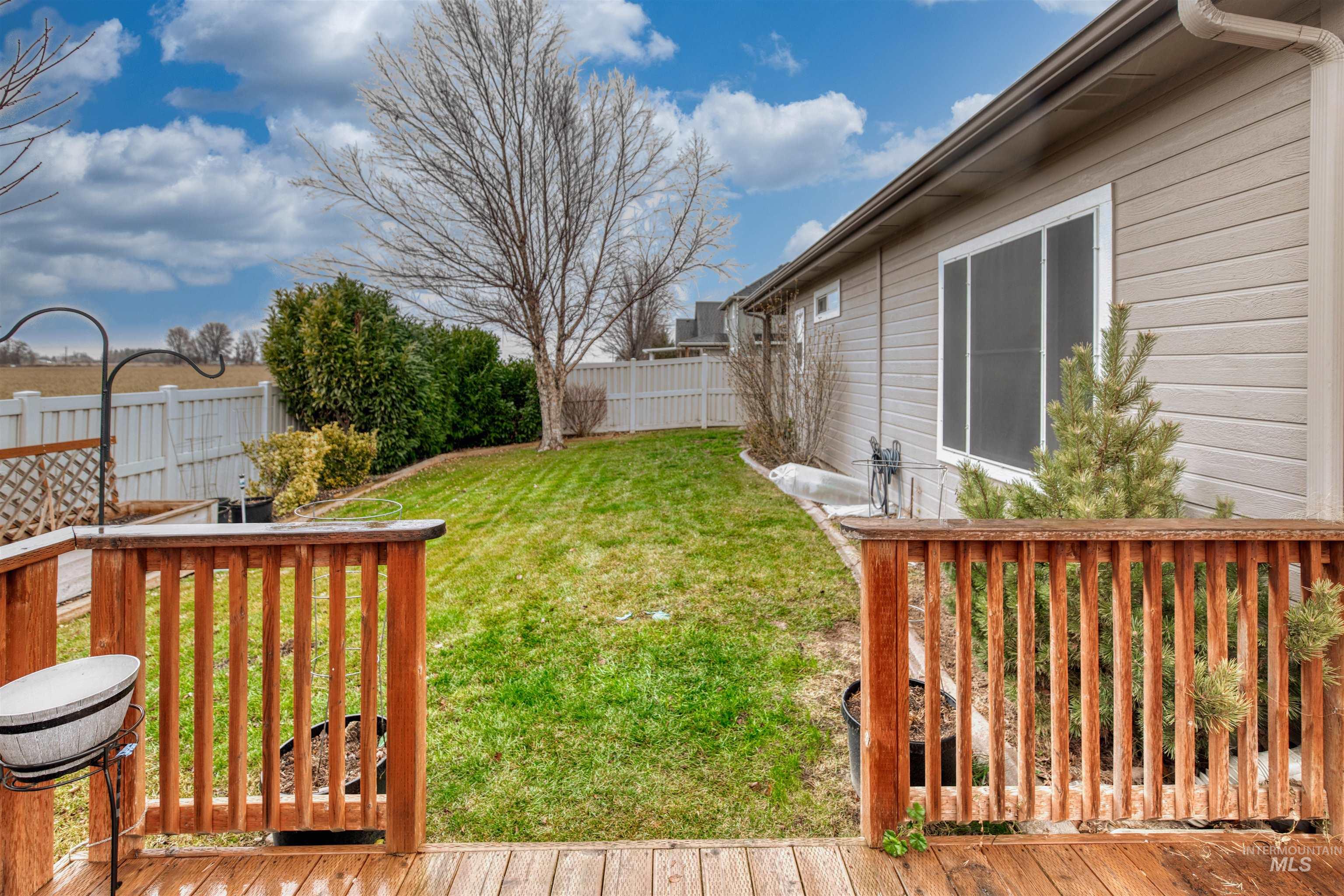 Fenced backyard featuring a wooden deck