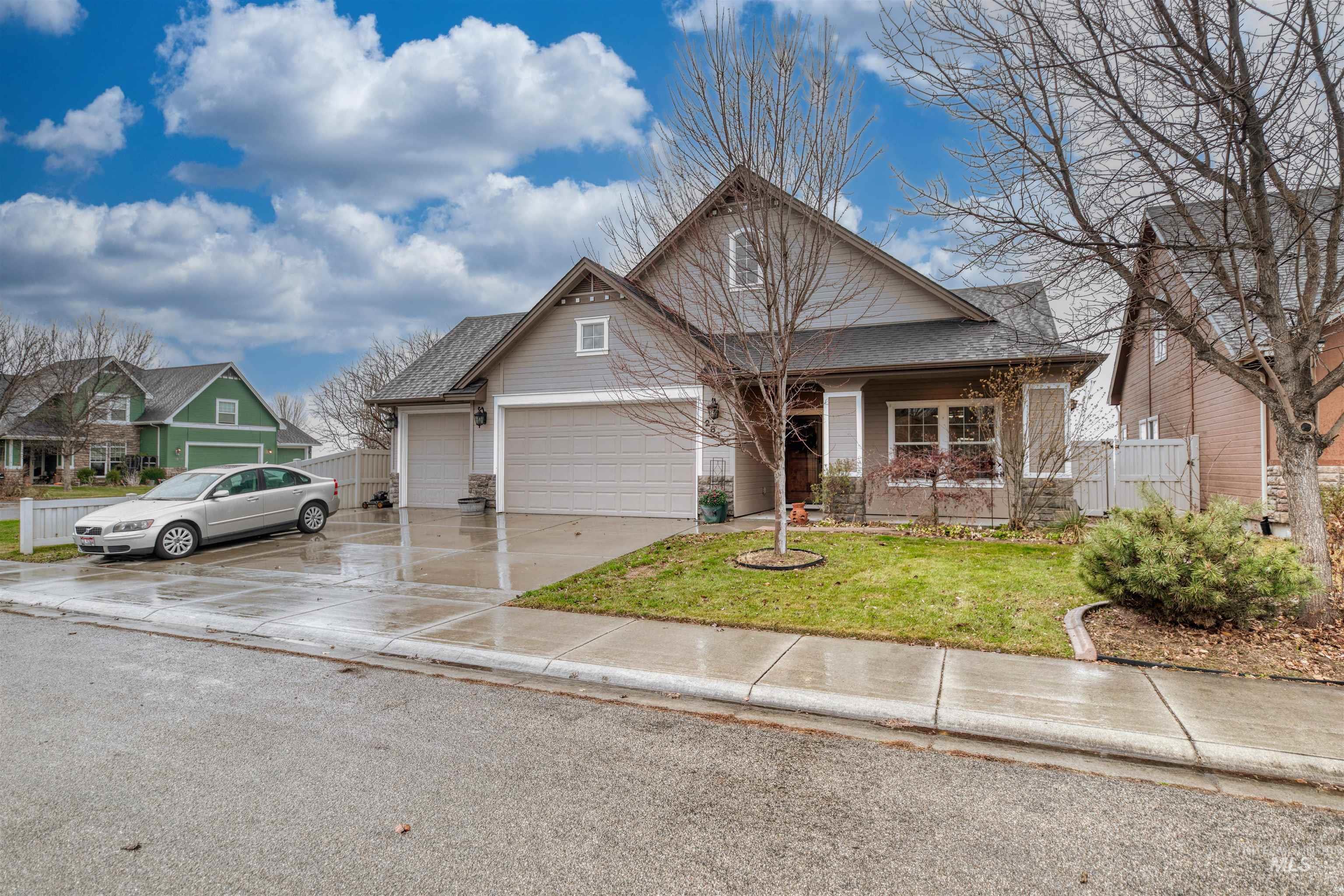 View of front of house featuring concrete driveway, a garage, and covered porch