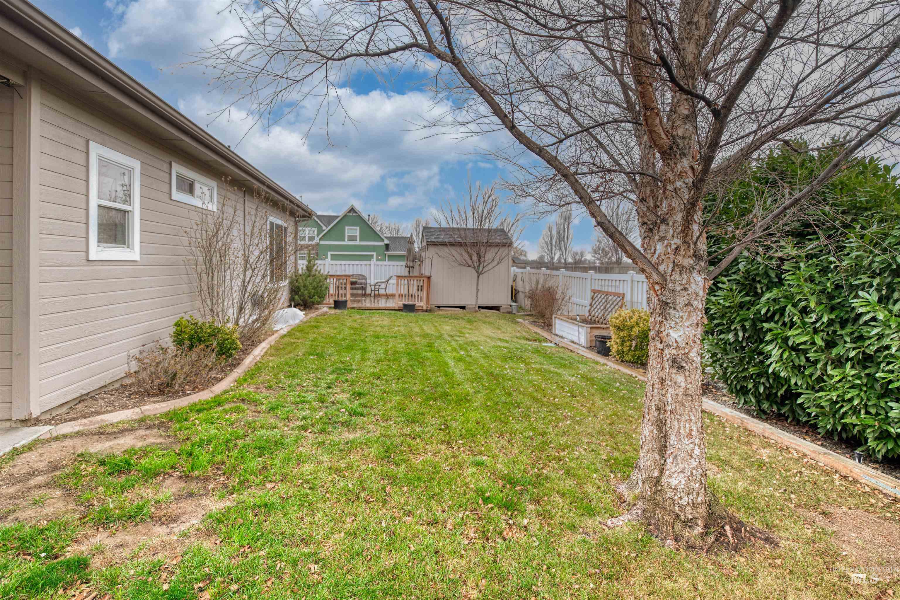 View of yard with a storage unit