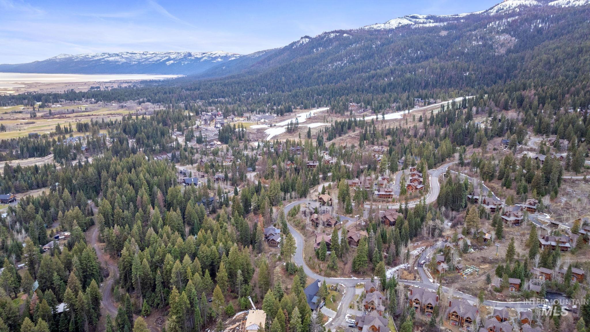 Aerial view of property's location with a mountain backdrop
