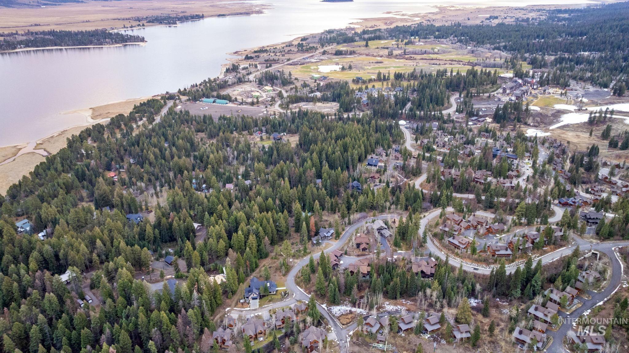 View of property location featuring a forest and a large body of water