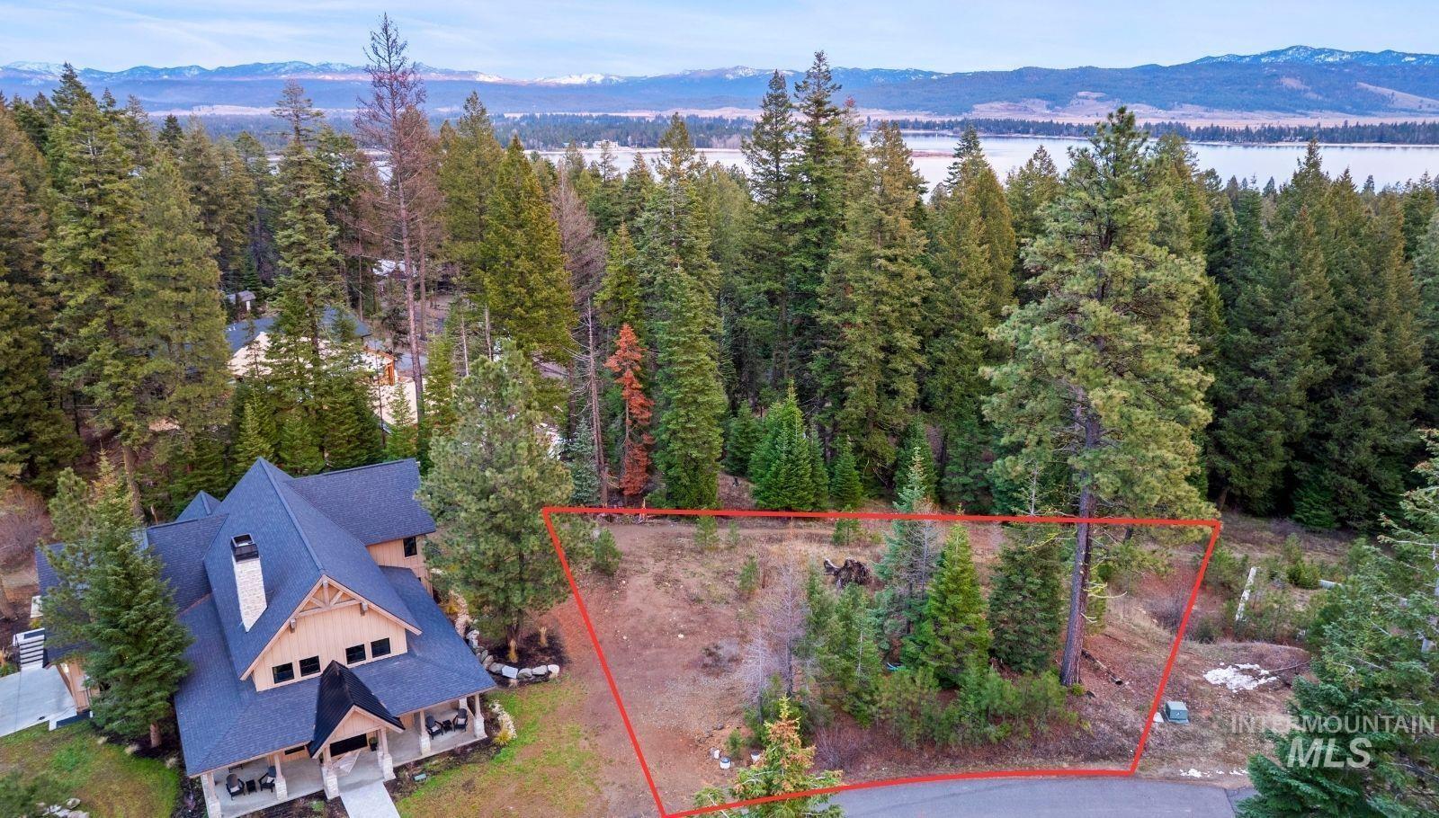 Aerial overview of property's location with a mountainous background and property boundaries highlighted