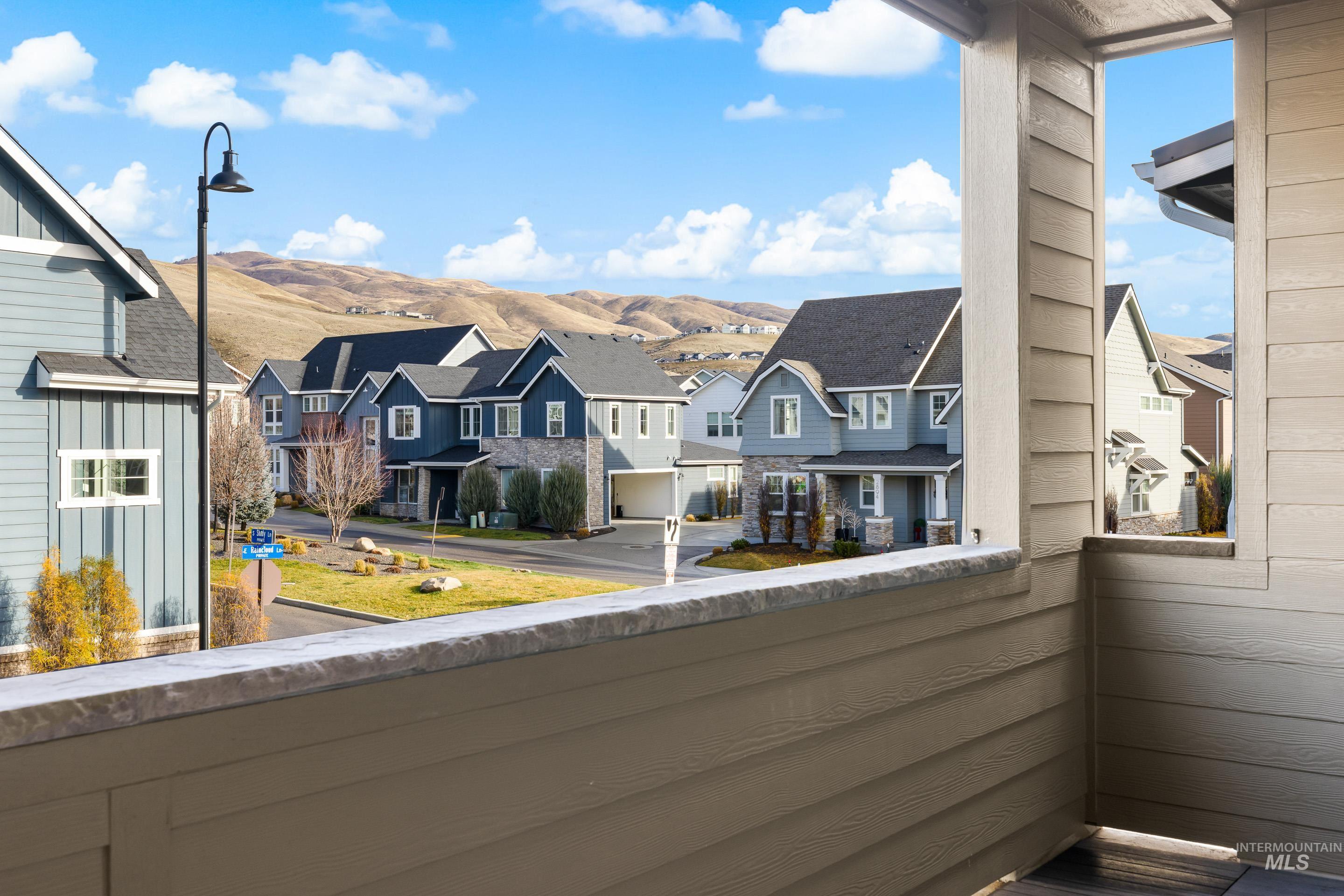 Balcony featuring a residential view and a mountain view