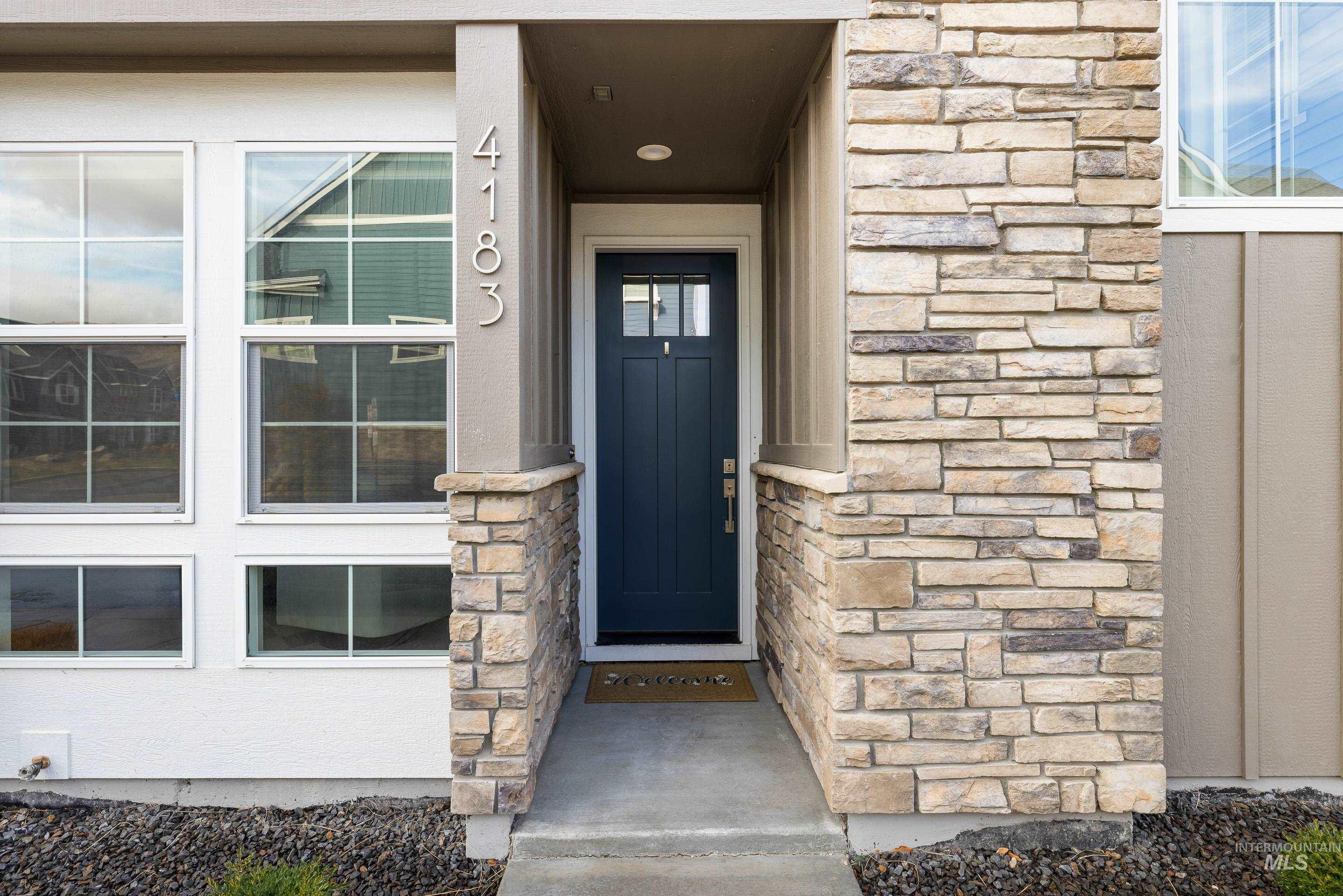 Property entrance featuring stone siding