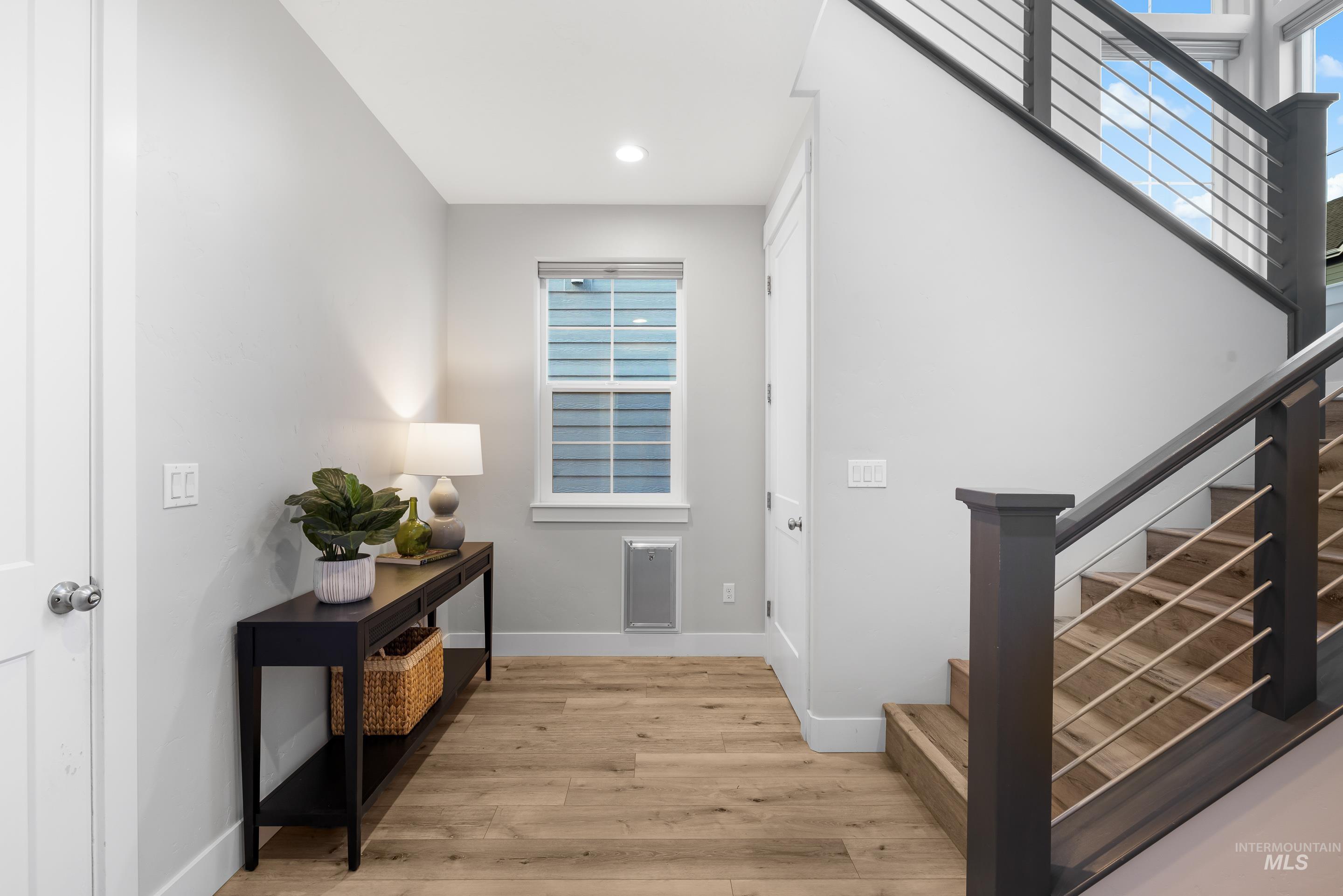 Entryway with stairway, light wood-type flooring, and recessed lighting
