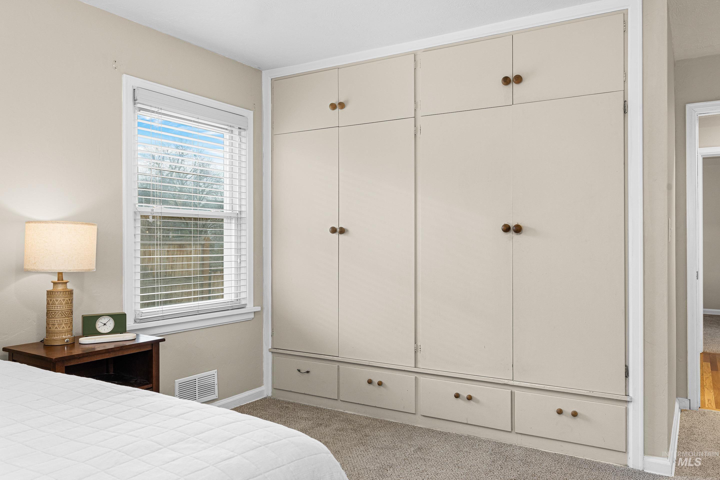 Bedroom featuring light carpet and a closet