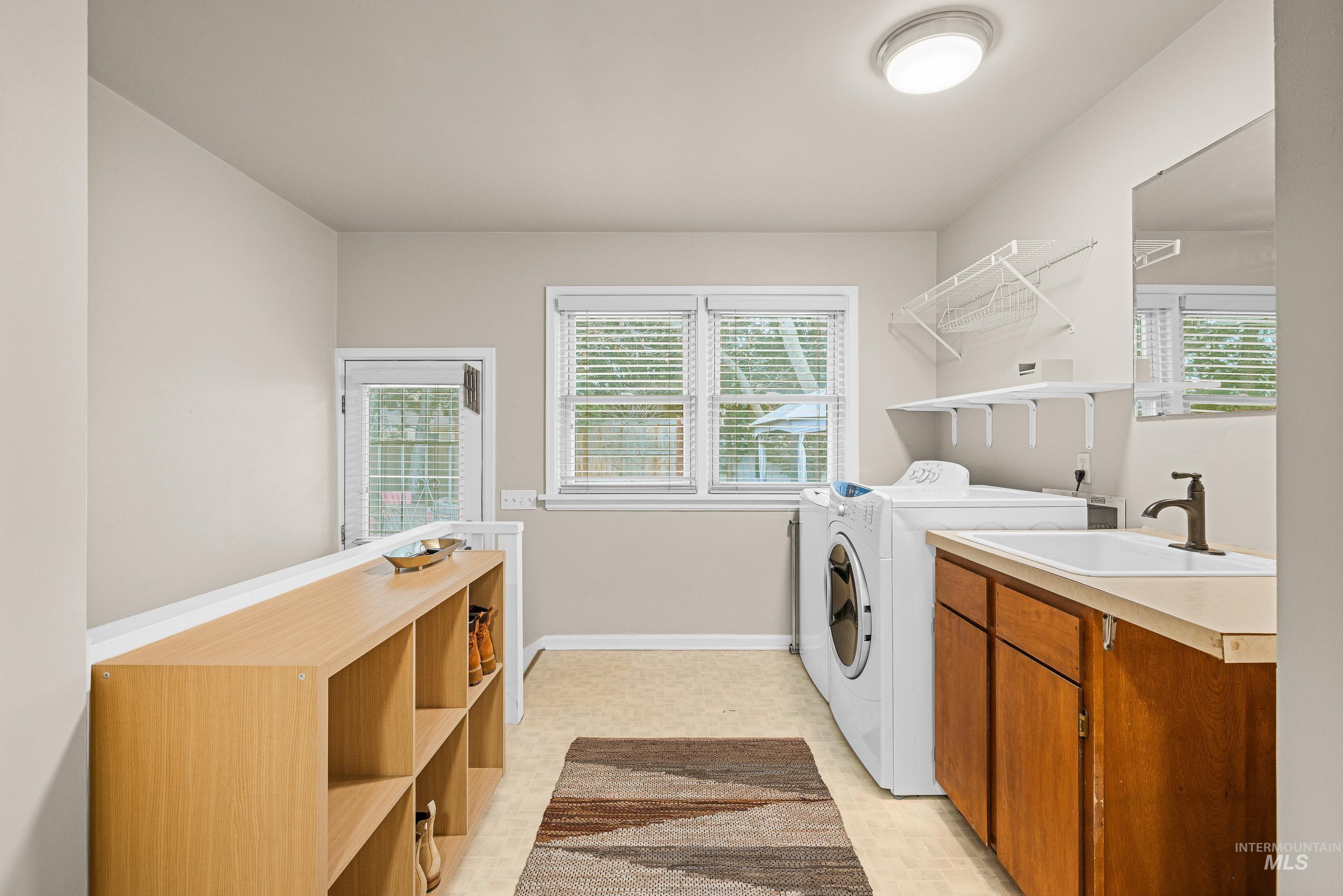 Washroom with independent washer and dryer and healthy amount of natural light