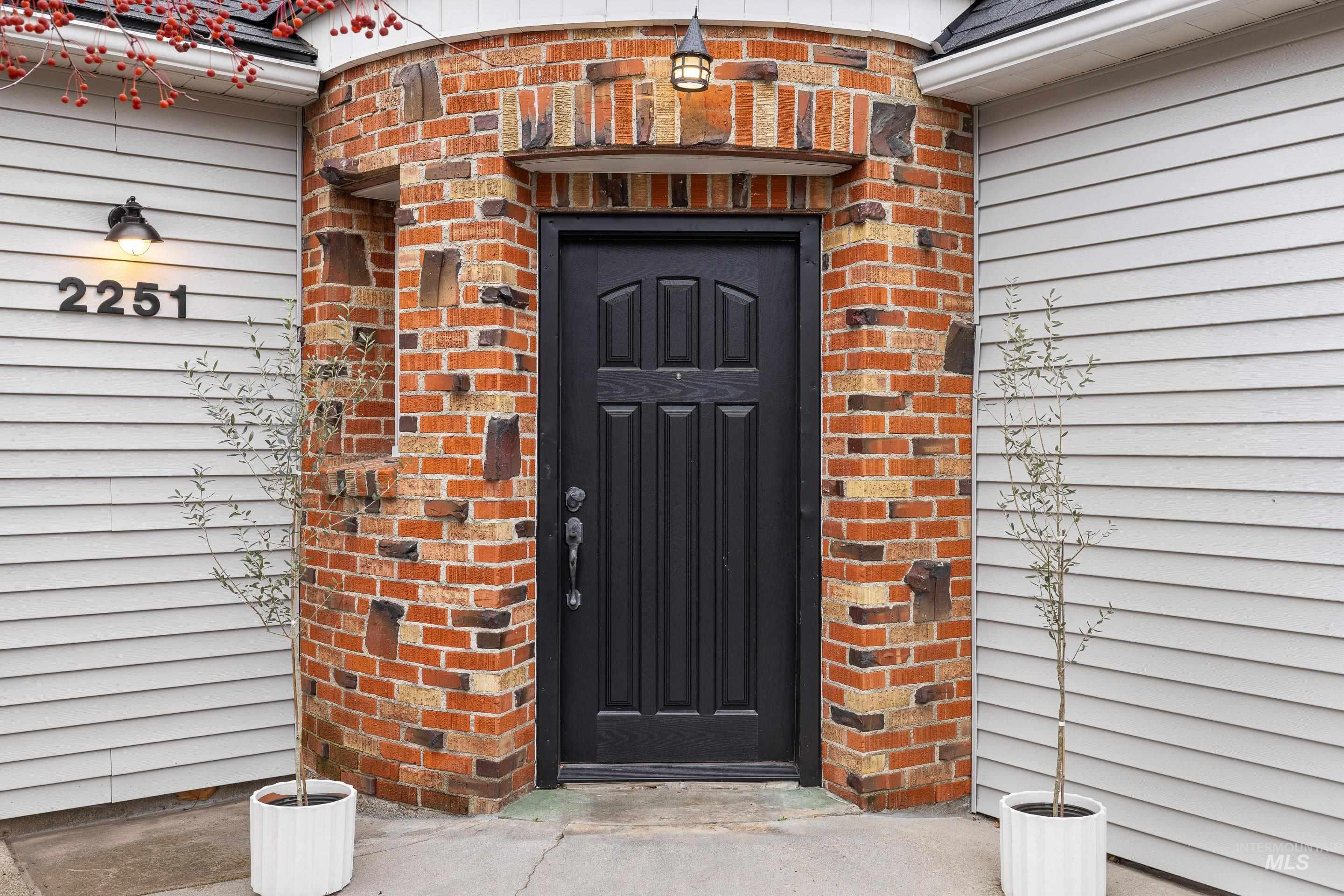 Doorway to property with brick siding