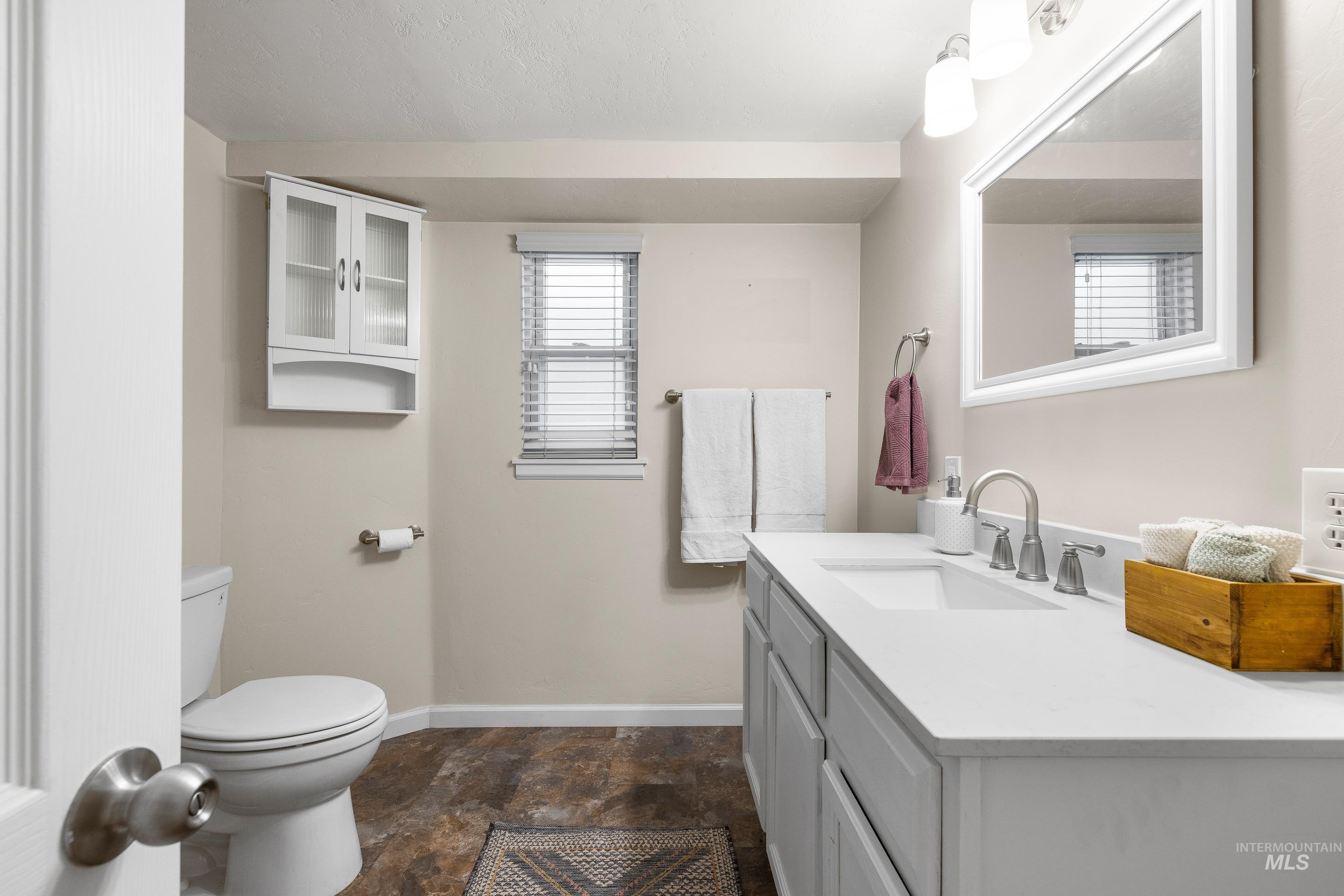 Bathroom with vanity and stone finish floors