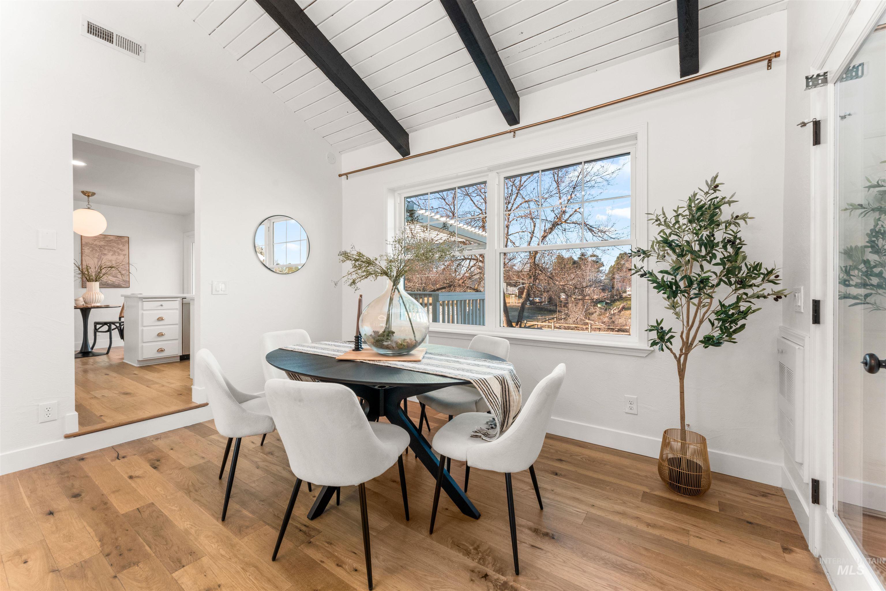 Dining room featuring light wood-style flooring and baseboards