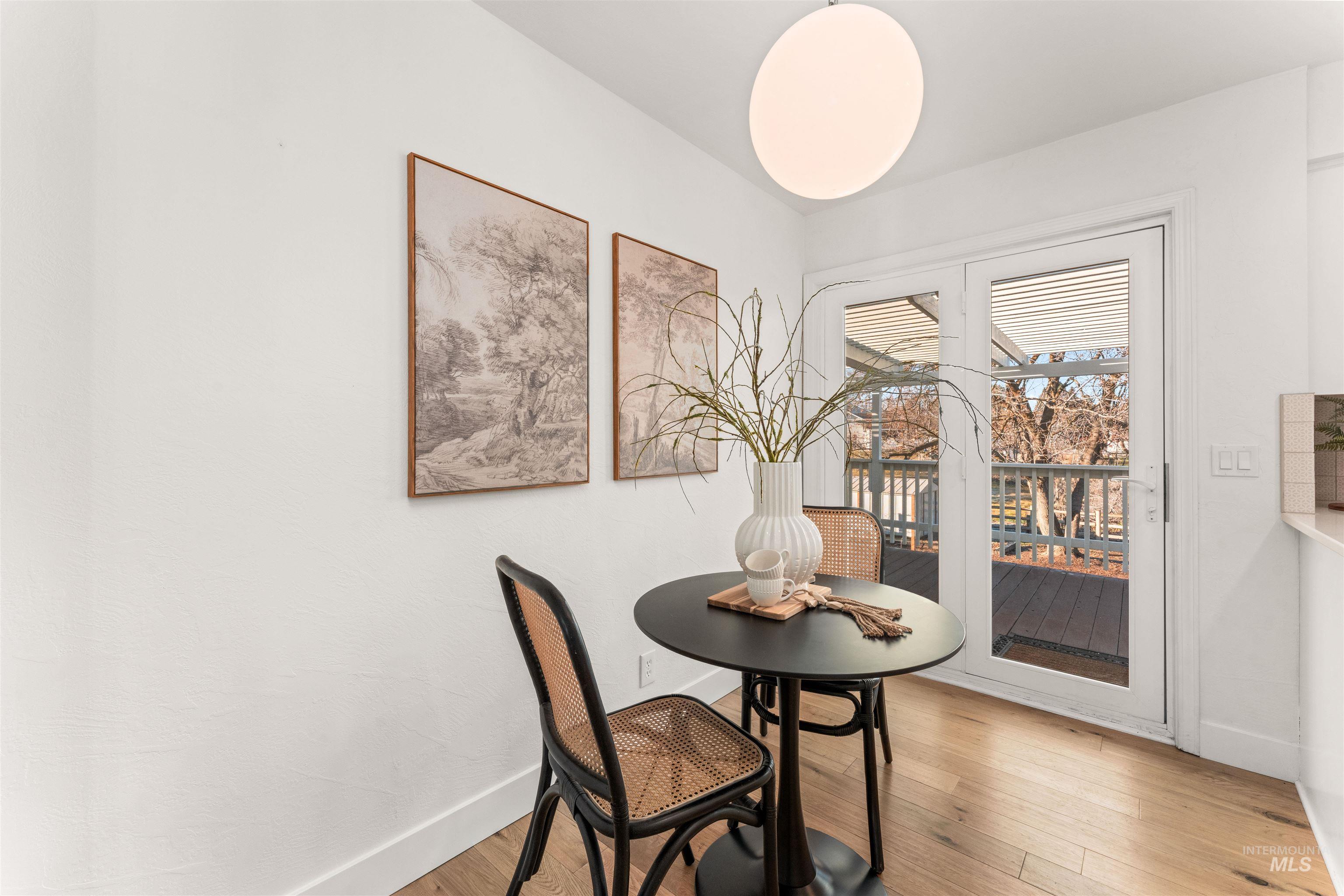 Dining area featuring light wood-style floors and baseboards