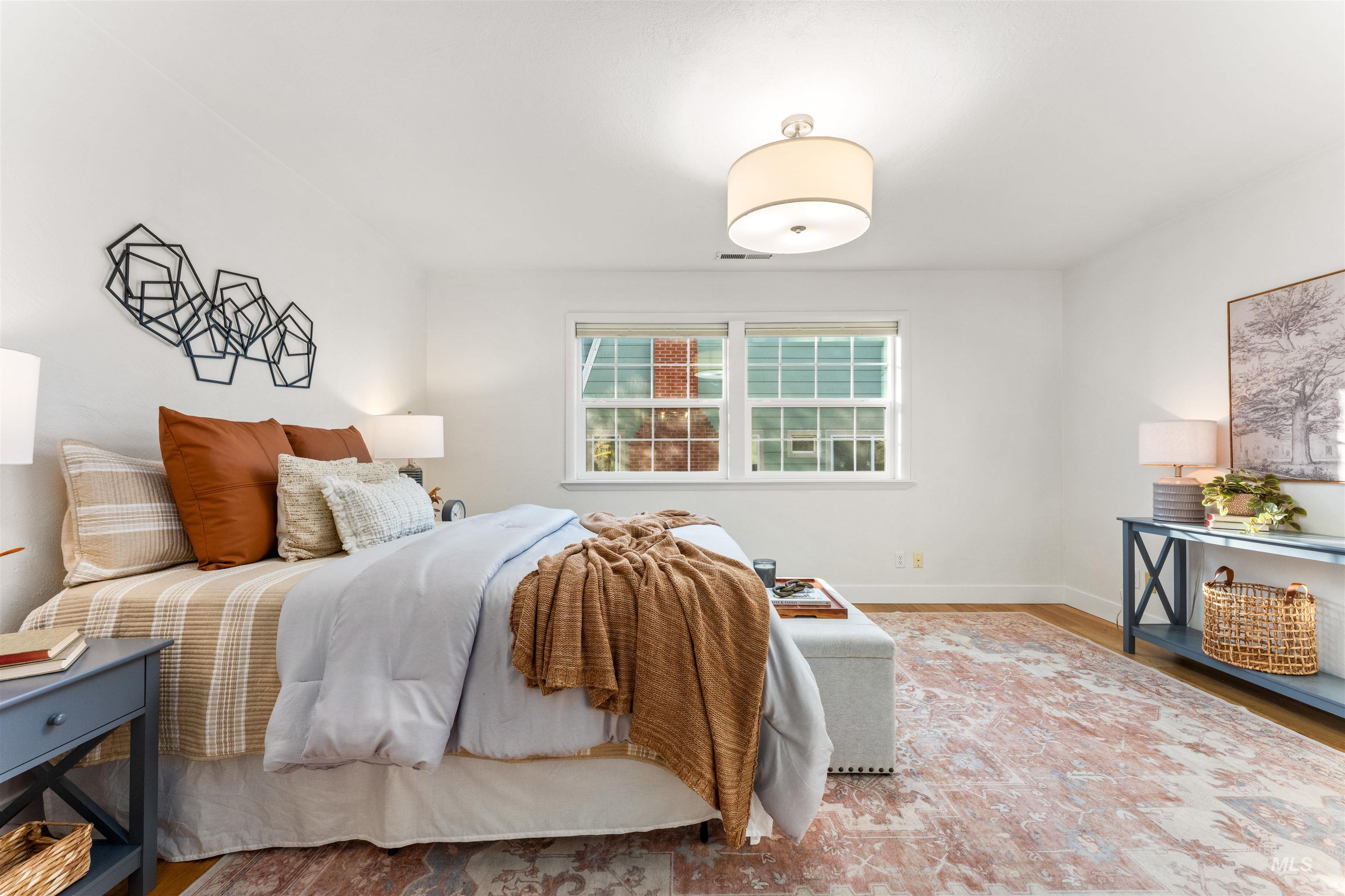 Bedroom featuring wood finished floors and baseboards