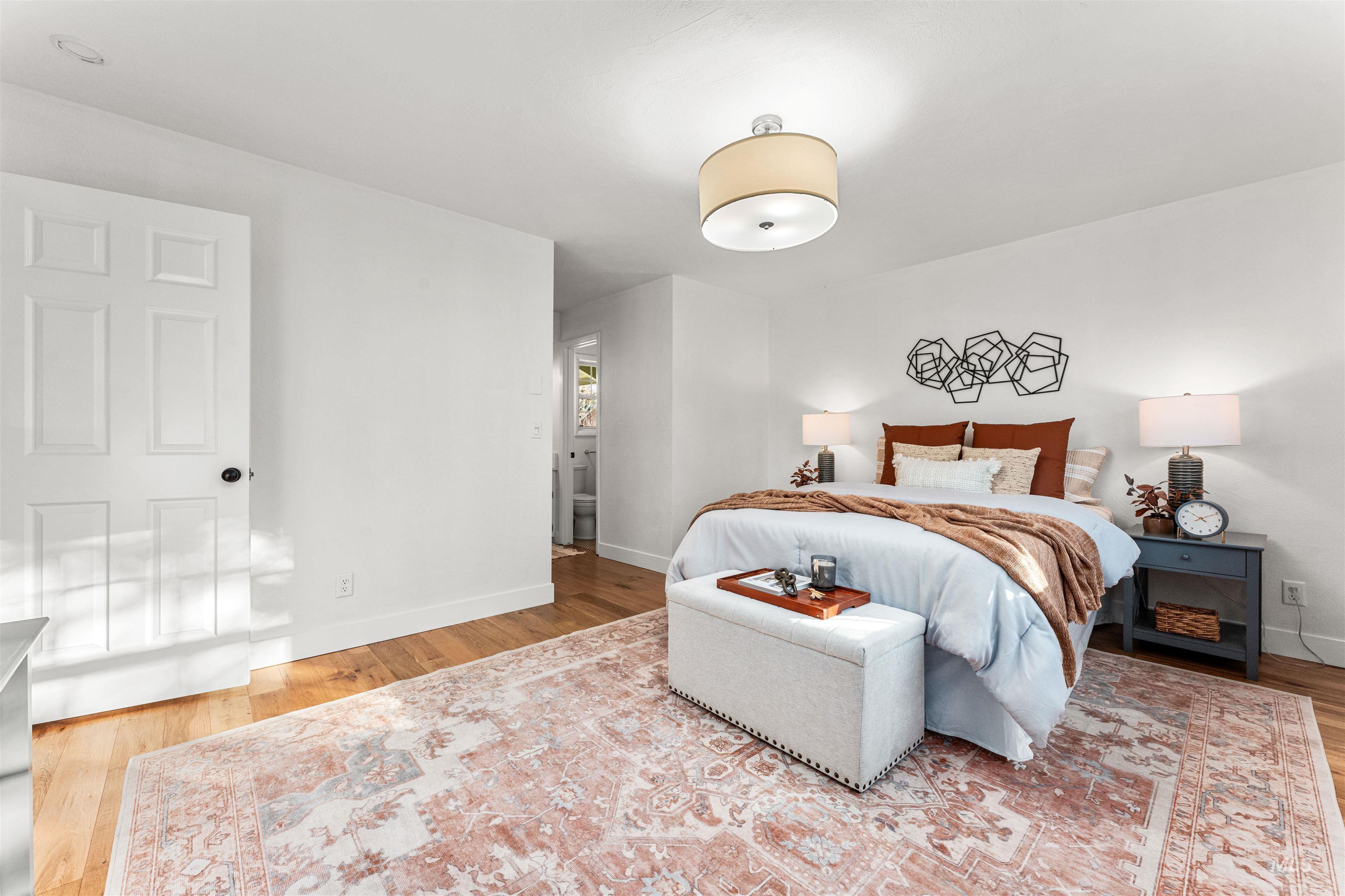 Bedroom featuring light wood-style floors and baseboards