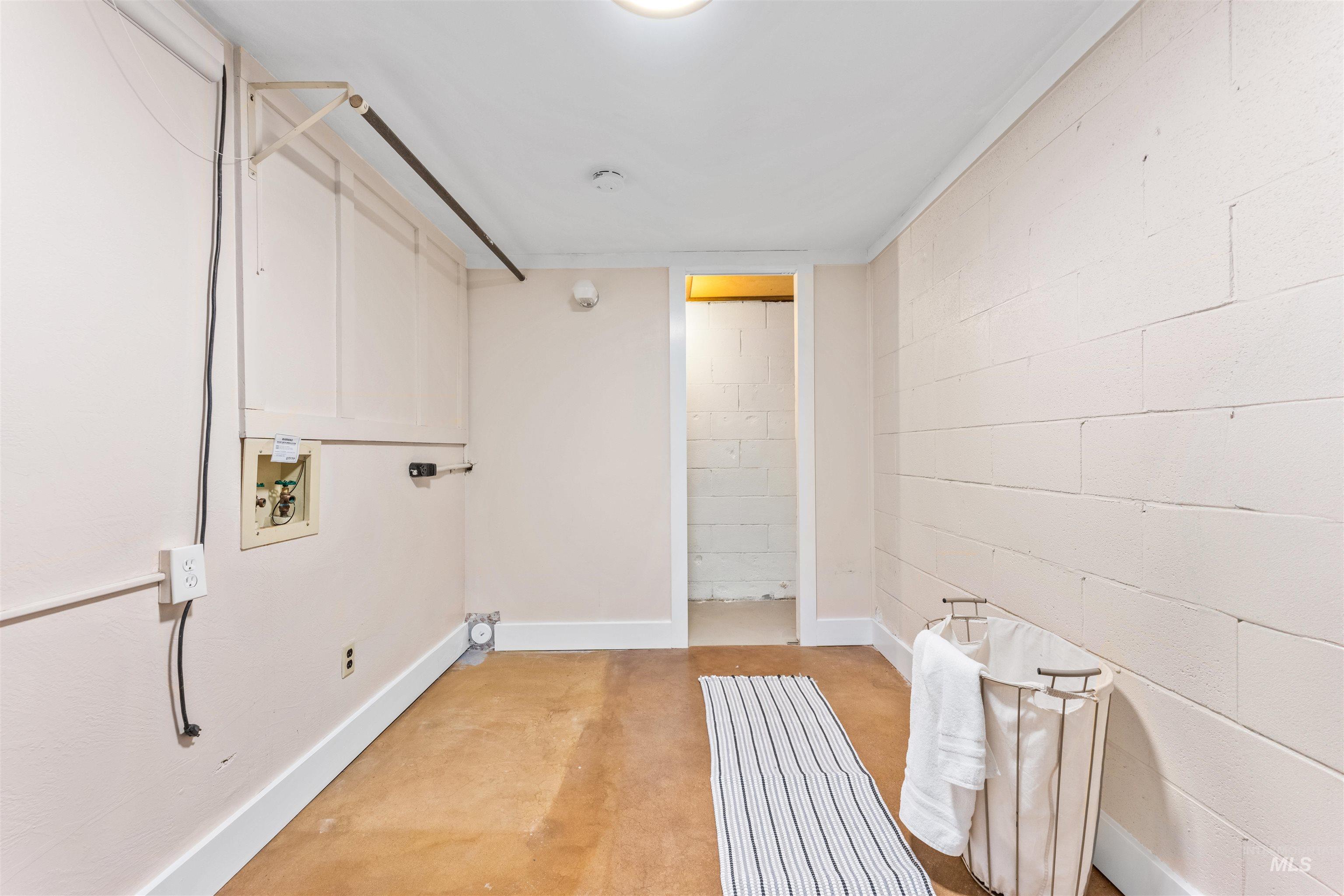 Laundry room with concrete floors and washer hookup