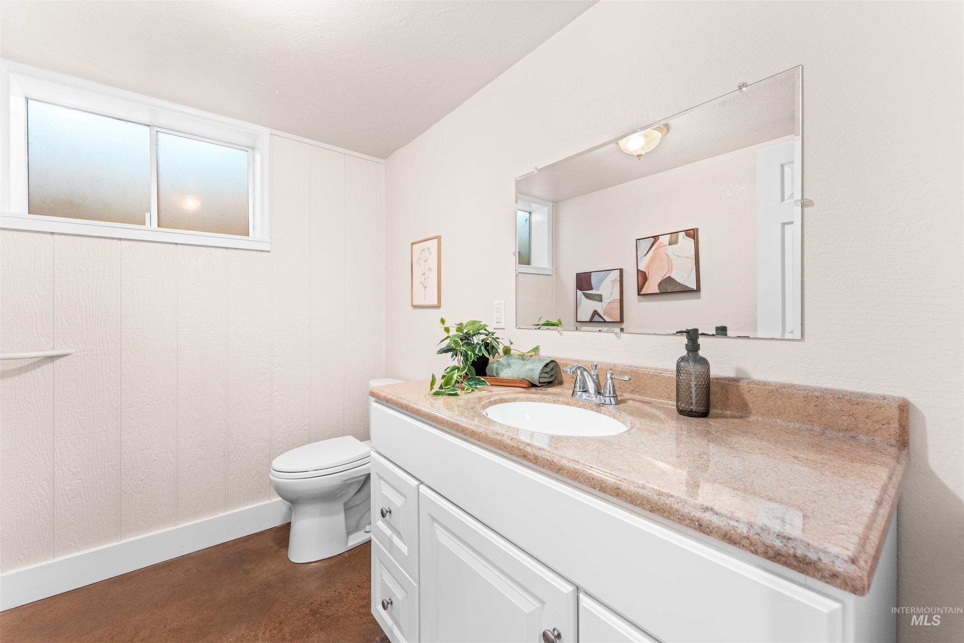 Bathroom with vanity and concrete floors