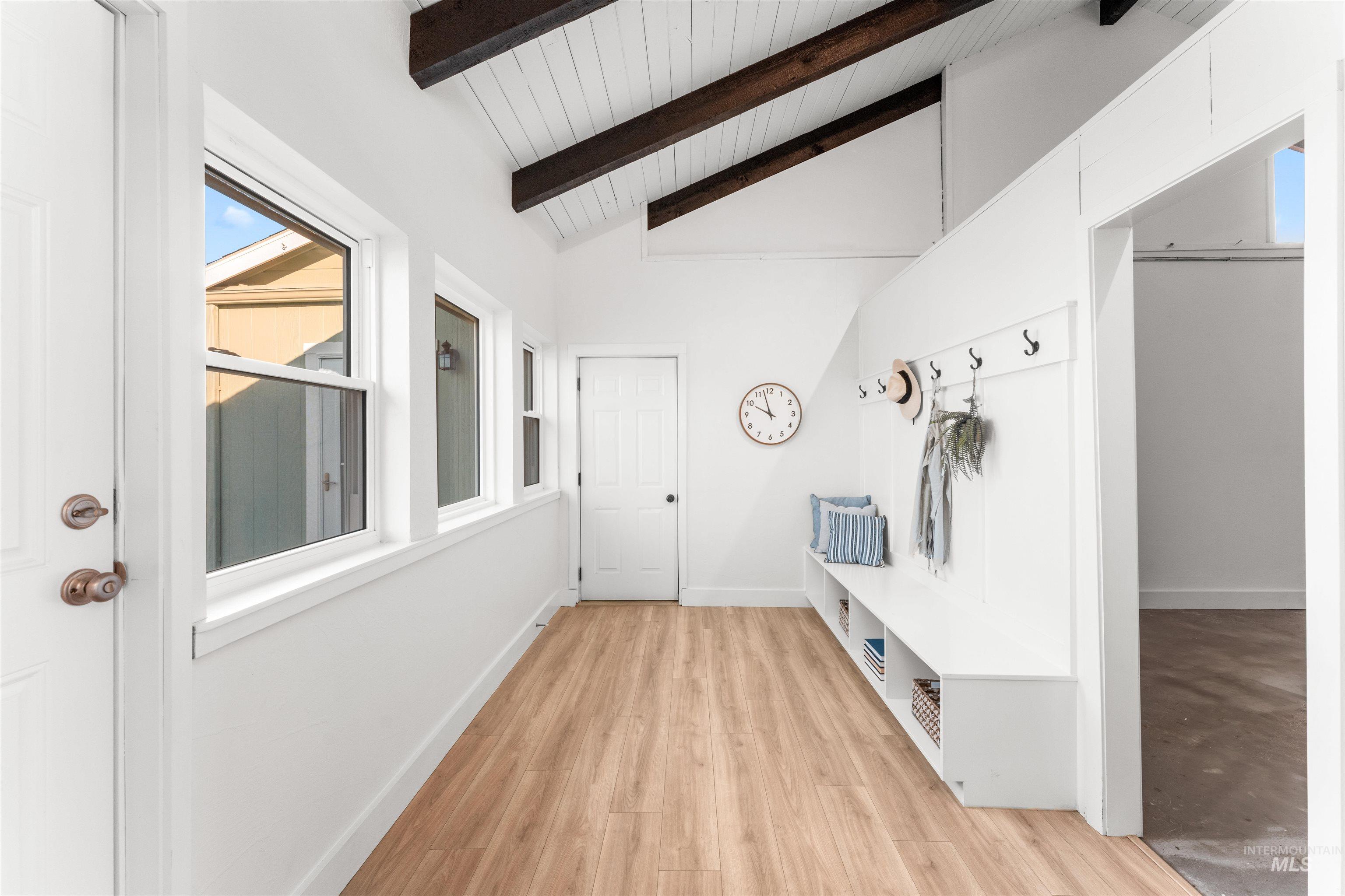 Mudroom with light wood-type flooring, high vaulted ceiling, and a wood ceiling with exposed beams