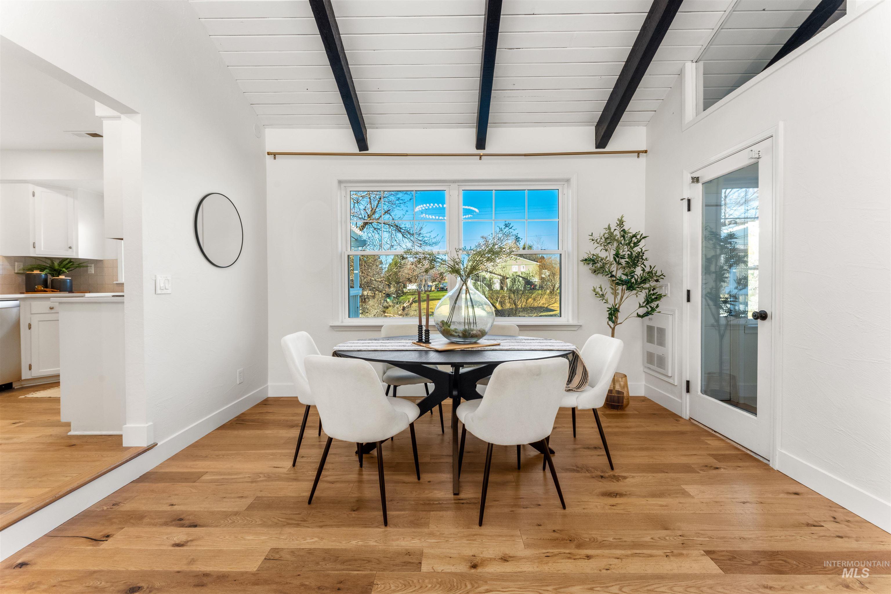 Dining area with healthy amount of natural light and light wood-type flooring