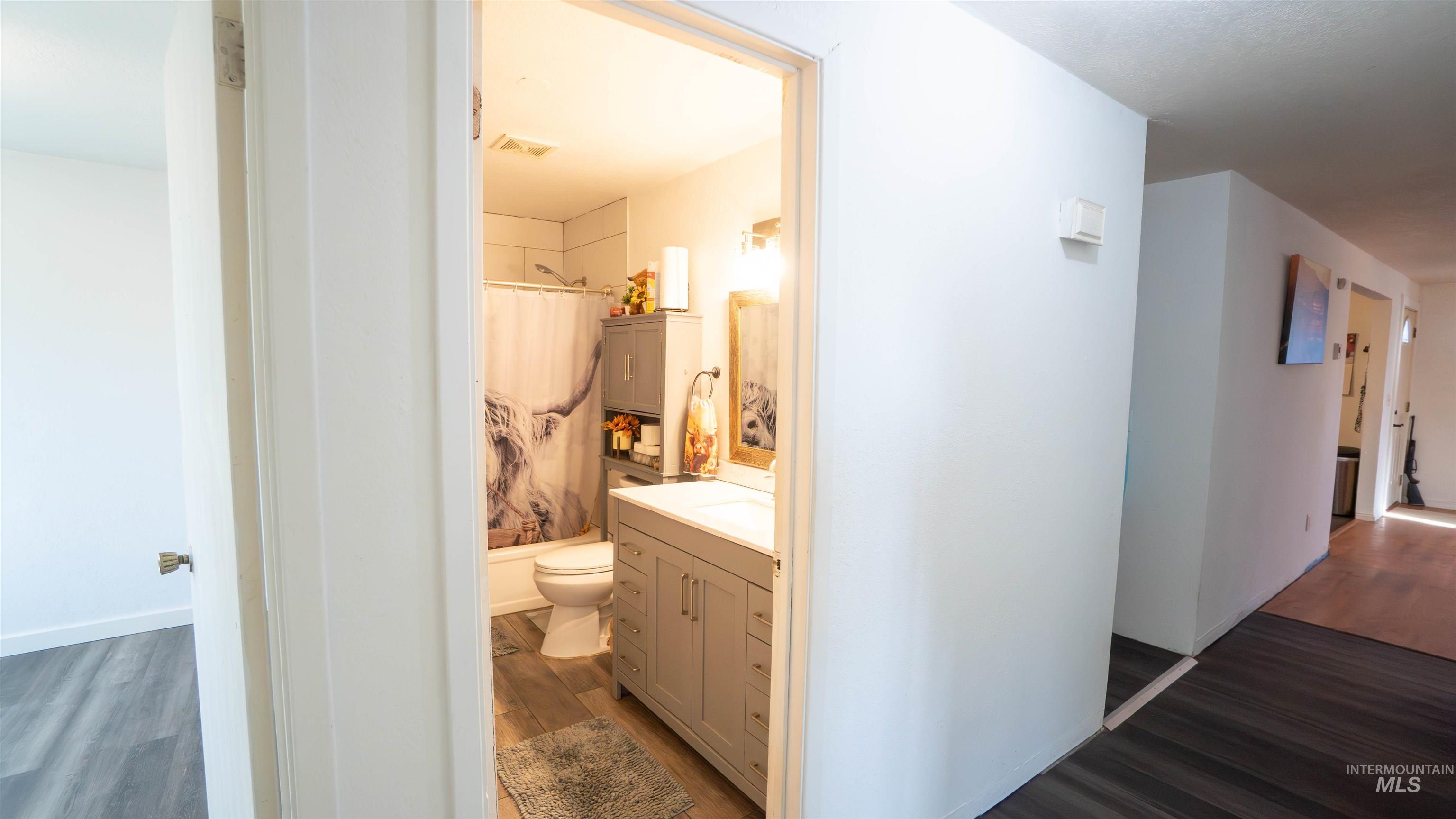 Hallway featuring dark wood finished floors