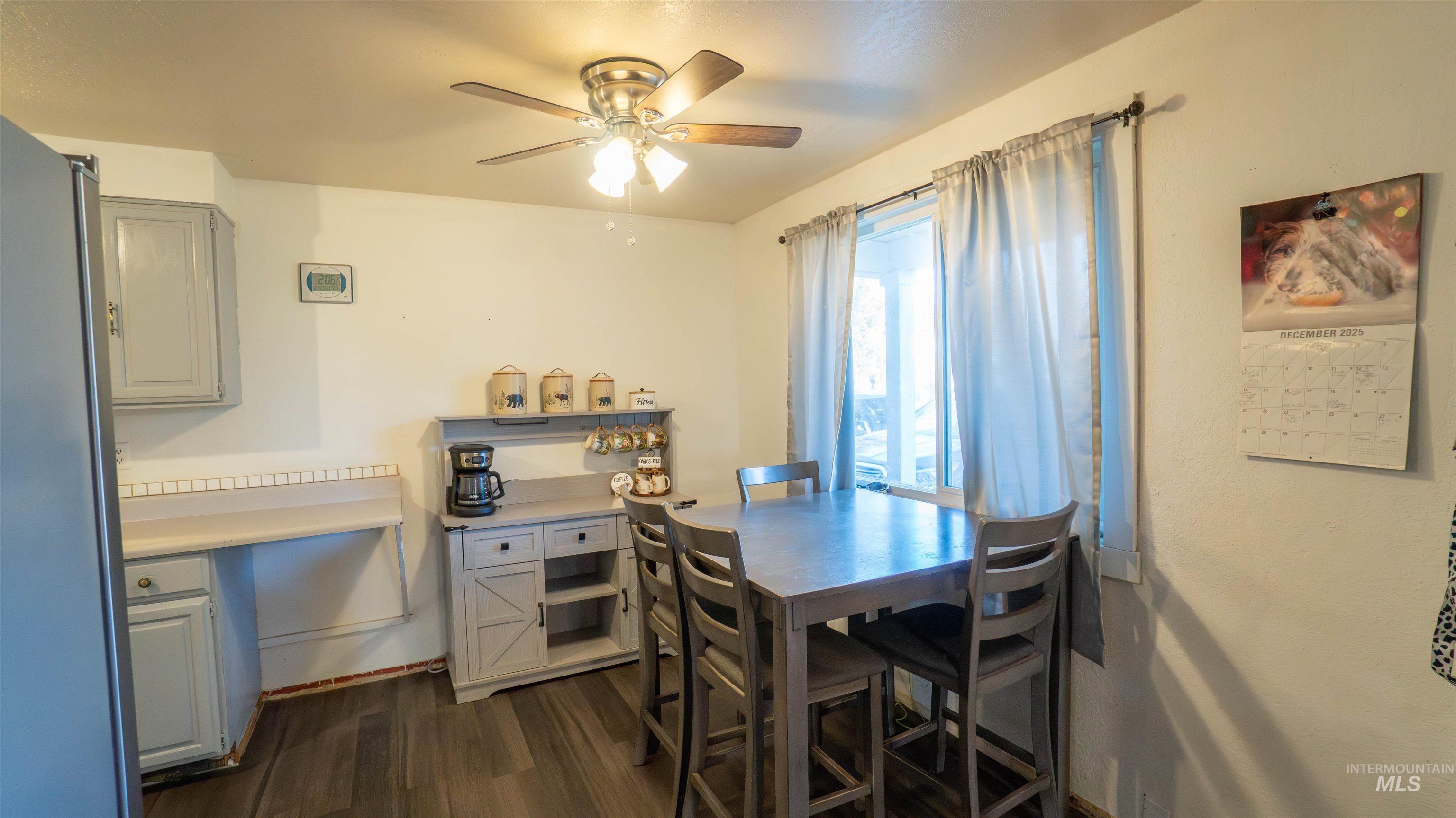 Dining room featuring dark wood finished floors and a ceiling fan