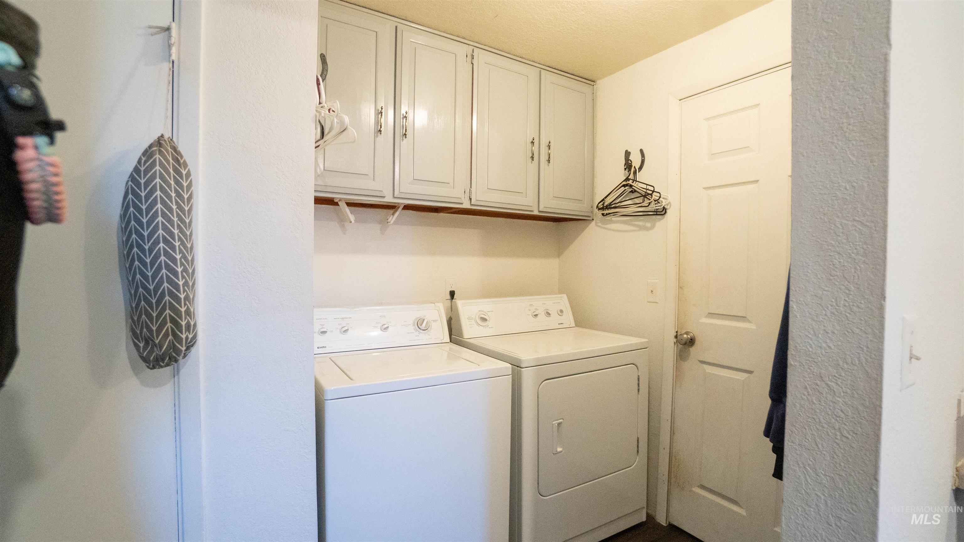 Laundry area featuring cabinet space and separate washer and dryer