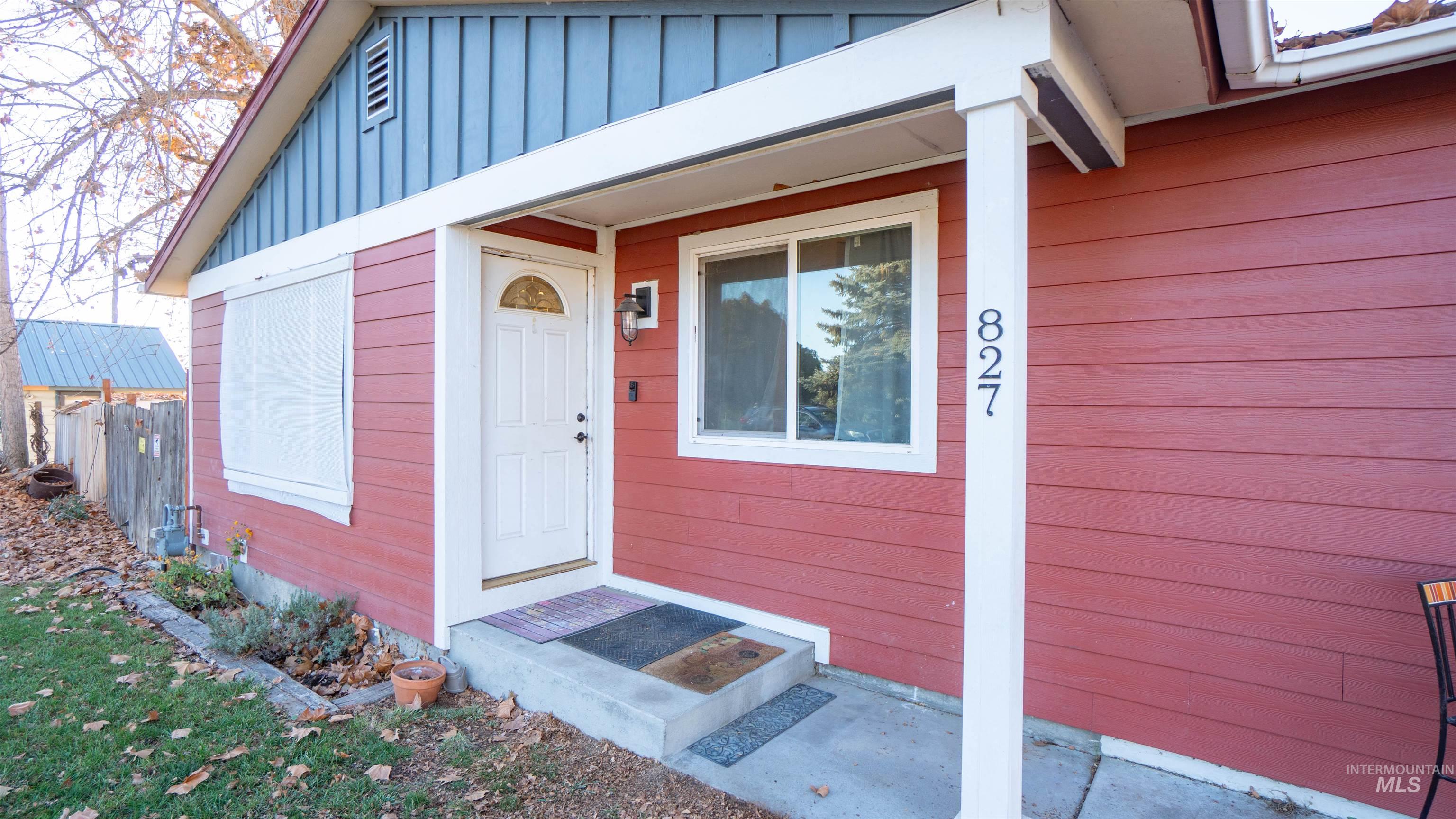 Doorway to property featuring board and batten siding